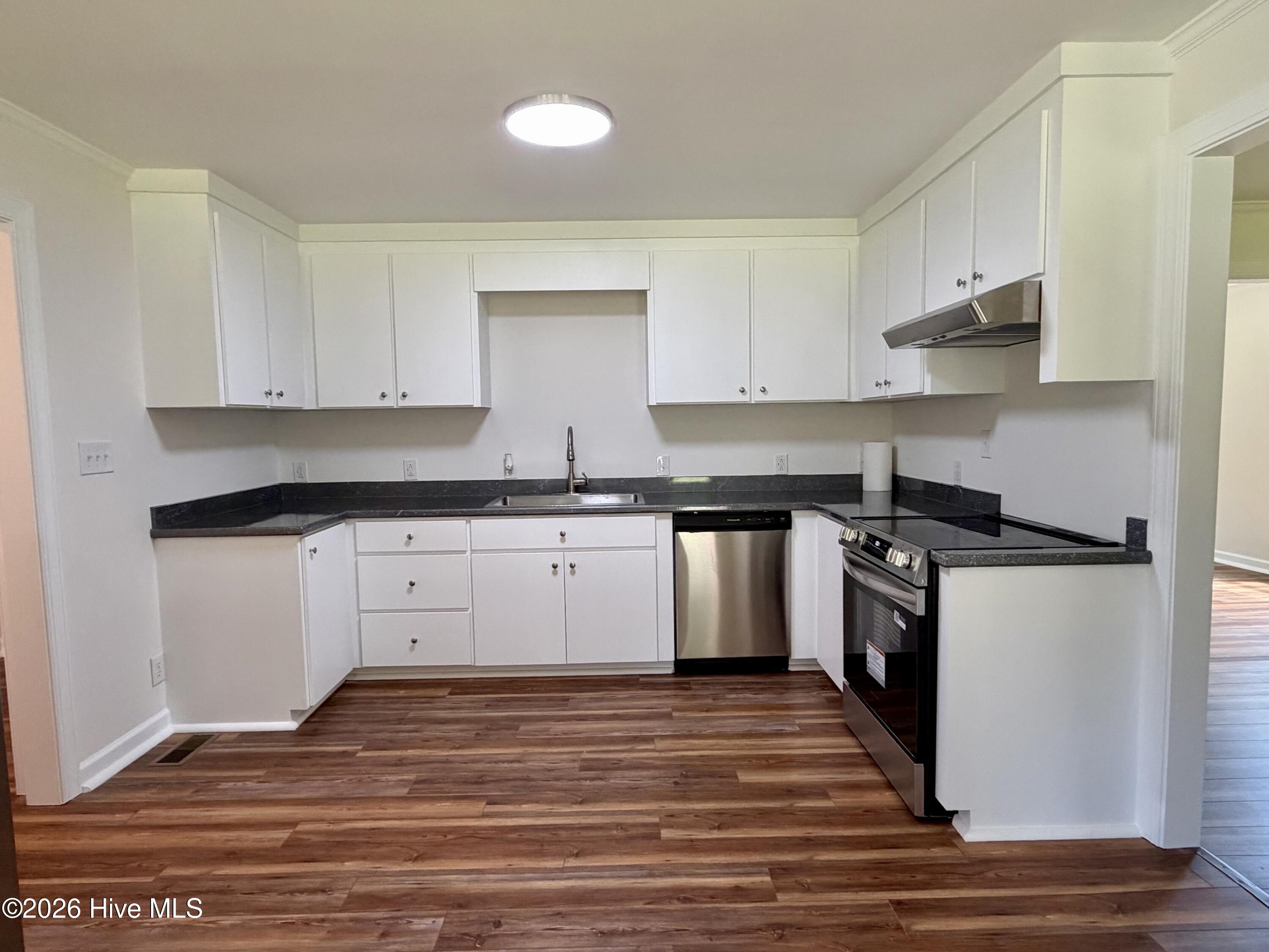 This spacious kitchen offers new cabinets, countertops, and new appliances.