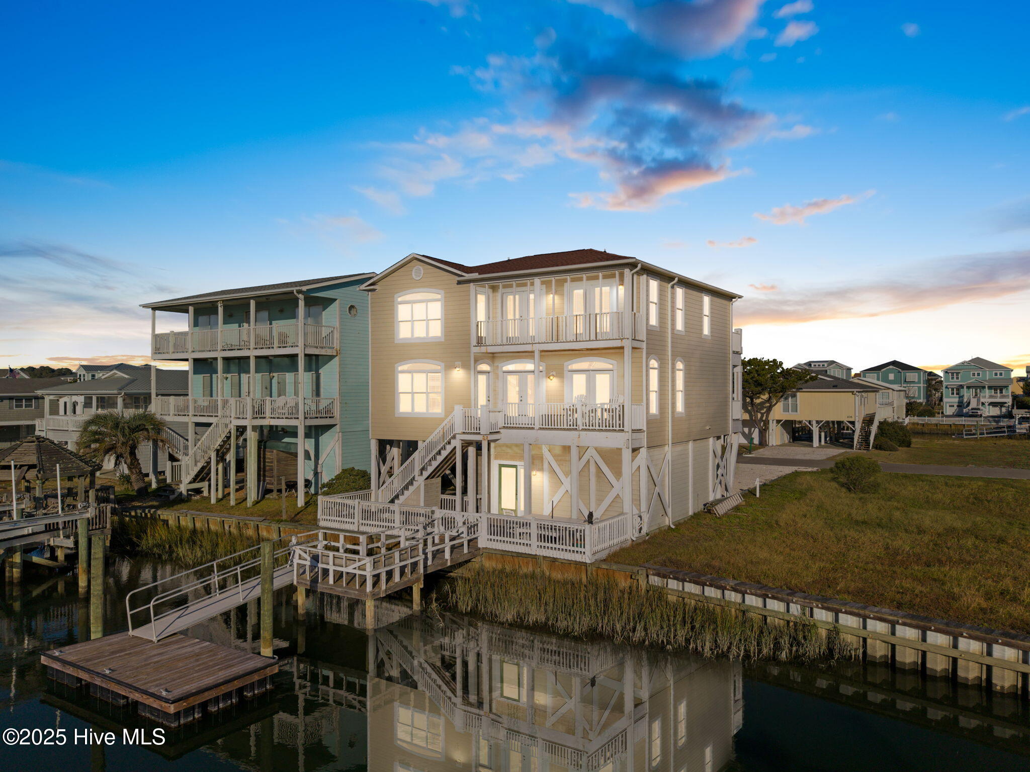 Ideal canal front living is found at 109 Salisbury St, Holden Beach. This spacious 4 bedroom, 4.5 bath canal front home with bulkhead, pier and floating dock gives you direct and private access to the canal, prepare for island living at its finest!Step inside to discover over 2400 sq ft of living space where you'll find a generous primary suite on the main living level along with a bright & airy kitchen and dinning room, spacious living room with a cozy gas fire place,  a living area on each floor, with plenty of room for large gatherings and family vacations, multiple decks to unwind and soak in the gorgeous views of the canal and peek-a-boo ocean views.  The ground floor provides abundant storage for all your beach gear, making it easy to embrace the laid-back coastal lifestyle. Expansive outdoor spaces lead down to the dock, creating the perfect setting for breezy afternoons, sunset celebrations, and the simple joy of life by the water. All just steps away from the nearest beach access. At 109 Salisbury St, Holden Beach, island living isn't just a dream- it's your new everyday reality.