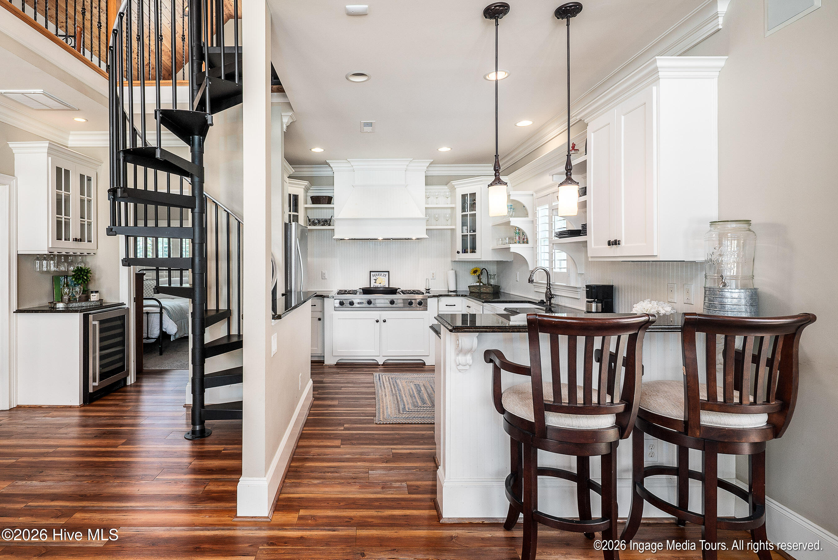 Guest house view of kitchen, and spiral stairs.