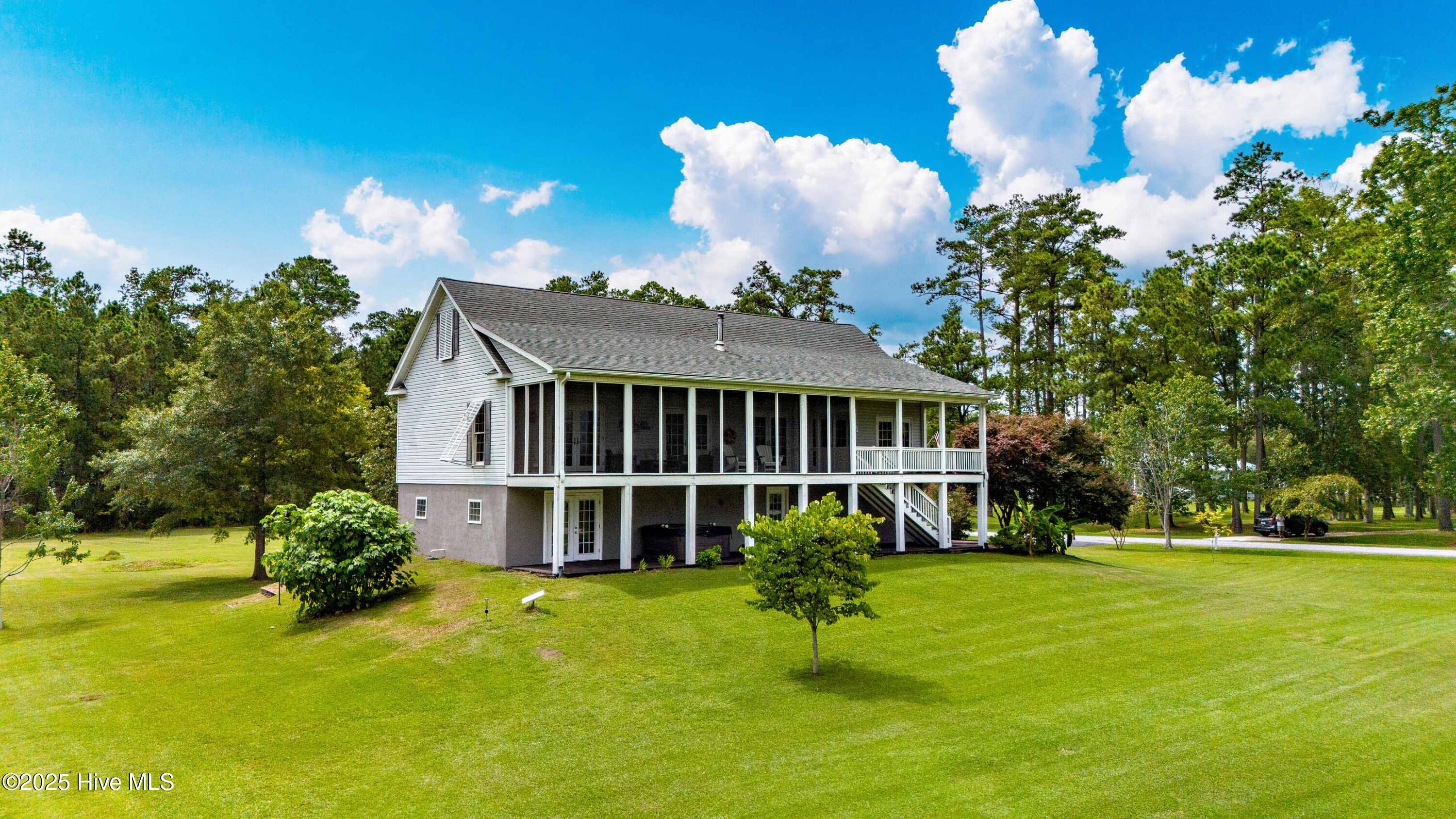 538 Mills Road Oriental, North Carolina Wake up to the beauty of Broad Creek, where breezes carry across the water and views stretch to Tar and Gideon Creeks. This elevated three-bedroom residence offers the perfect blend of thoughtful design, comfort, and flexibility—inviting you to relax, entertain, and make the most of coastal living.
Set high on a raised building pad above the floodplain, the home offers peace of mind, requires no flood insurance, and delivers scenic waterviews. The property spans 1.2 acres total, with an extra lot—ideal for a guest cottage. On the ground level, a paved drive leads to the oversized two-car garage with more than 1,600 square feet of enclosed space. This level also includes a heated studio area and an adjoining storage room—perfect for hobbies. A full-length covered patio extends across the back, offering a shady spot for projects or entertaining.
Upstairs, expansive porches—including a 36' x 9' screened porch—invite you to savor the views and breezes. French doors from the living room and all bedrooms provide direct porch access, creating seamless indoor-outdoor flow. A Quadra-Fire wood stove warms the living room on winter nights, hardwood floors add warmth and charm, and the kitchen shines as the home's centerpiece with abundant cabinetry, generous counters, a built-in office nook, and newer appliances—dishwasher, stove, and refrigerator all replaced within the past two years.
The primary suite is a private retreat, filled with natural light and spacious enough for a reading or music area, complete with a luxurious ensuite bath. Two additional bedrooms, a full bath, and a convenient laundry room round out the floor plan.
Recent updates include a roof replacement (2018), HVAC system (2021), and a premium Kinetico water softener with reverse osmosis.
This property combines elevated design, versatile living spaces and waterview beauty- all with the confidence of no flood insurance required.