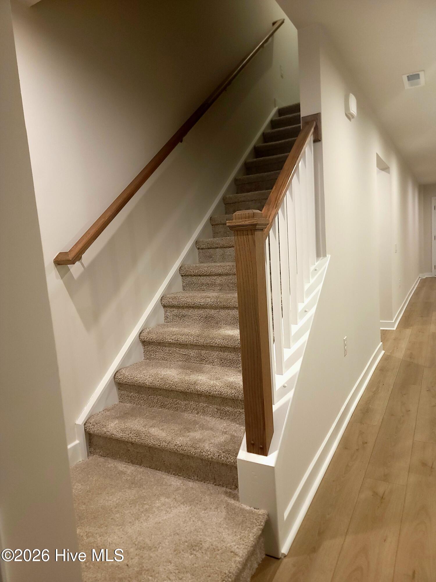 Nice open staircase adding charm to the kitchen/living room areas.