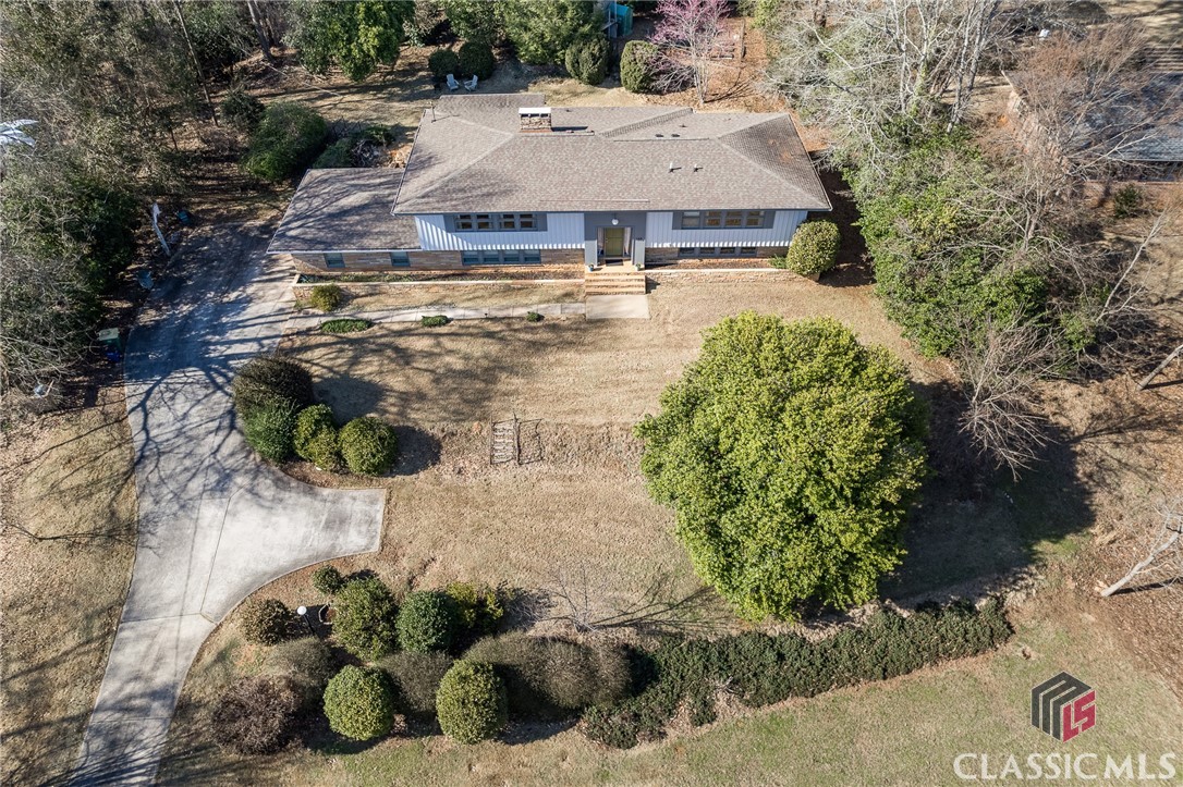 This wonderful split foyer mid-century home in the Glenwood neighborhood of Five Points is full of charm and has loads of space. This 4 bedroom, 3.5 bathroom home features 3009 square feet of living space. From the entry going up, you will find a large living area with a fireplace. Beyond the living area, you will find a dining room and kitchen that overlook the beautiful backyard and covered porch. On this same level, you will find the primary suite with an updated bathroom, two additional bedrooms, and one full bathroom. From the entry going down you will find another large living area with a fireplace. There is an additional bedroom with an ensuite bath and another half bath. The garage has been enclosed for storage and to add a workshop space. This home features beautiful hardwood floors, new windows, and a new HVAC. You will love the proximity to dining, shopping, and more that Five Points offers. 145 Lullwater Rd is less than two miles from the University of Georgia and less than five miles from our local hospitals.