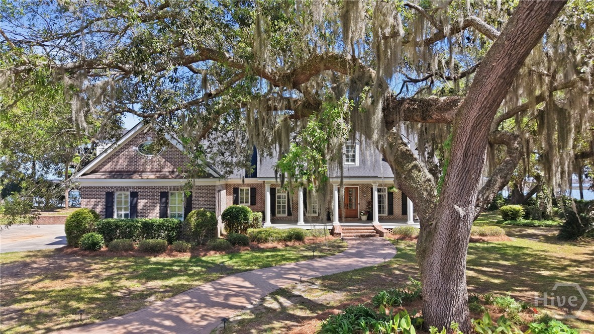 Oak trees grace the circular drive.