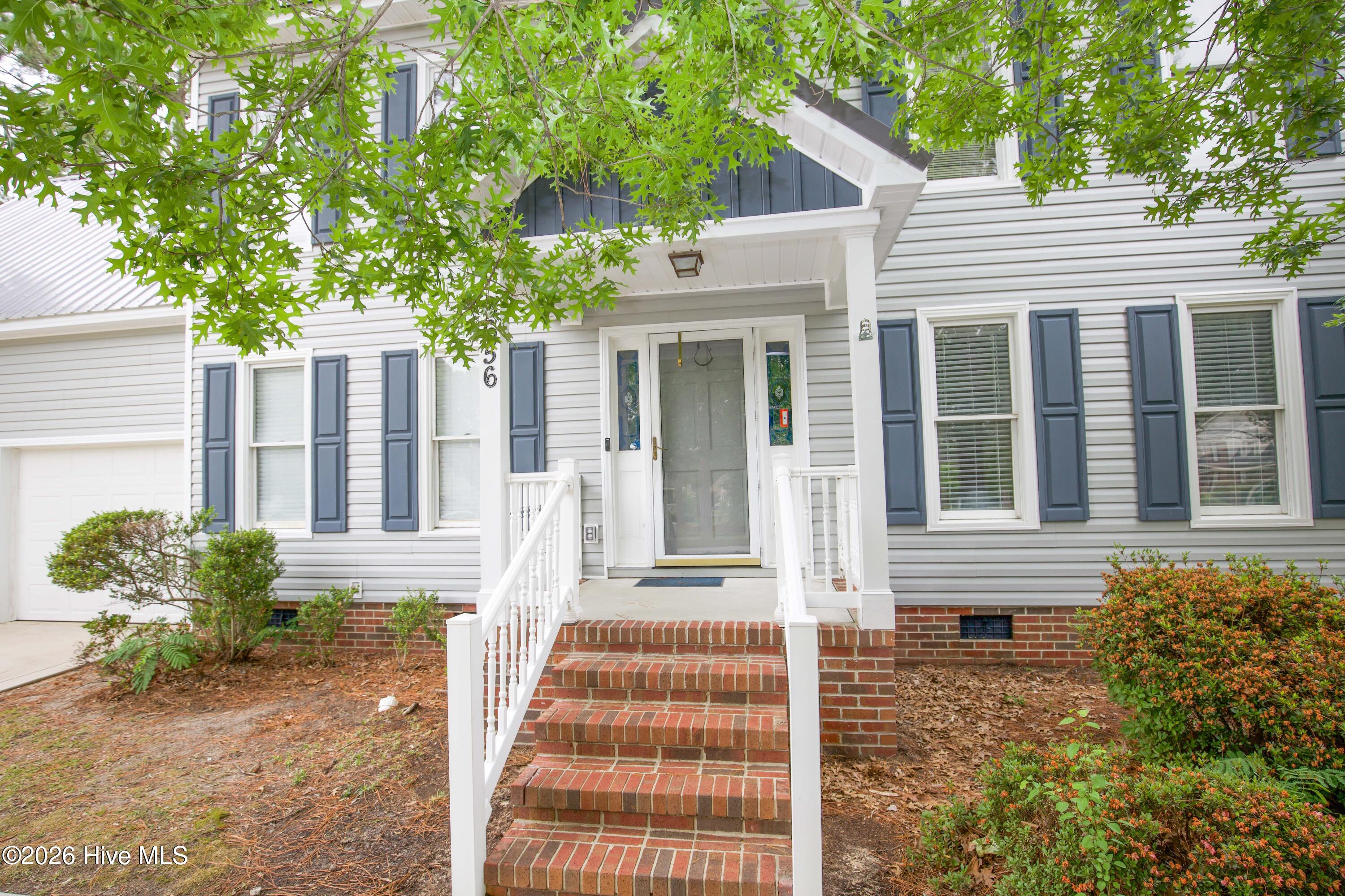 nviting covered front porch and entryway featuring brick steps, updated exterior finishes, mature landscaping, and welcoming curb appeal. This well-maintained Fayetteville home in Wells Place offers spacious living areas, outdoor entertaining space, and convenient access to Fort Bragg, shopping, dining, and commuter routes throughout Cumberland County.
