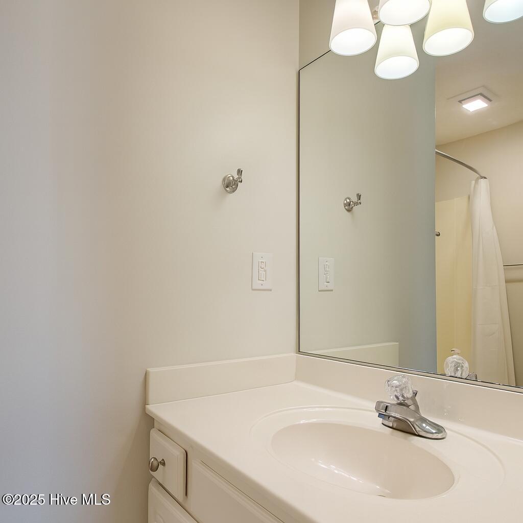 9117 Landing Drive SW, Calabash, NC 28467 – photo 16: Modern Bathroom Vanity and Reflective Mi