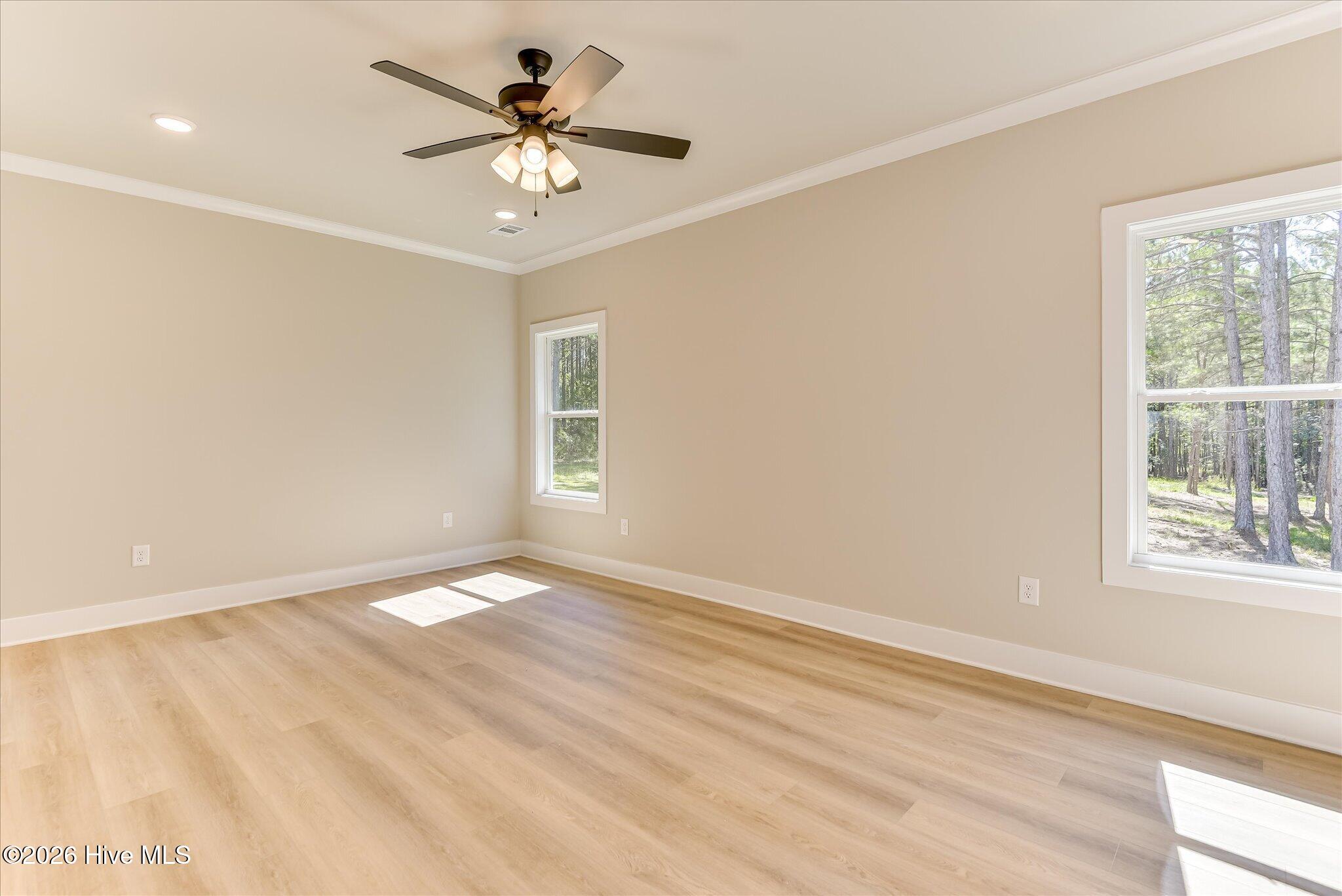 Primary Bedroom with large walk-in closet, ensuite bathroom, and french doors to the screened porch is Downstairs.