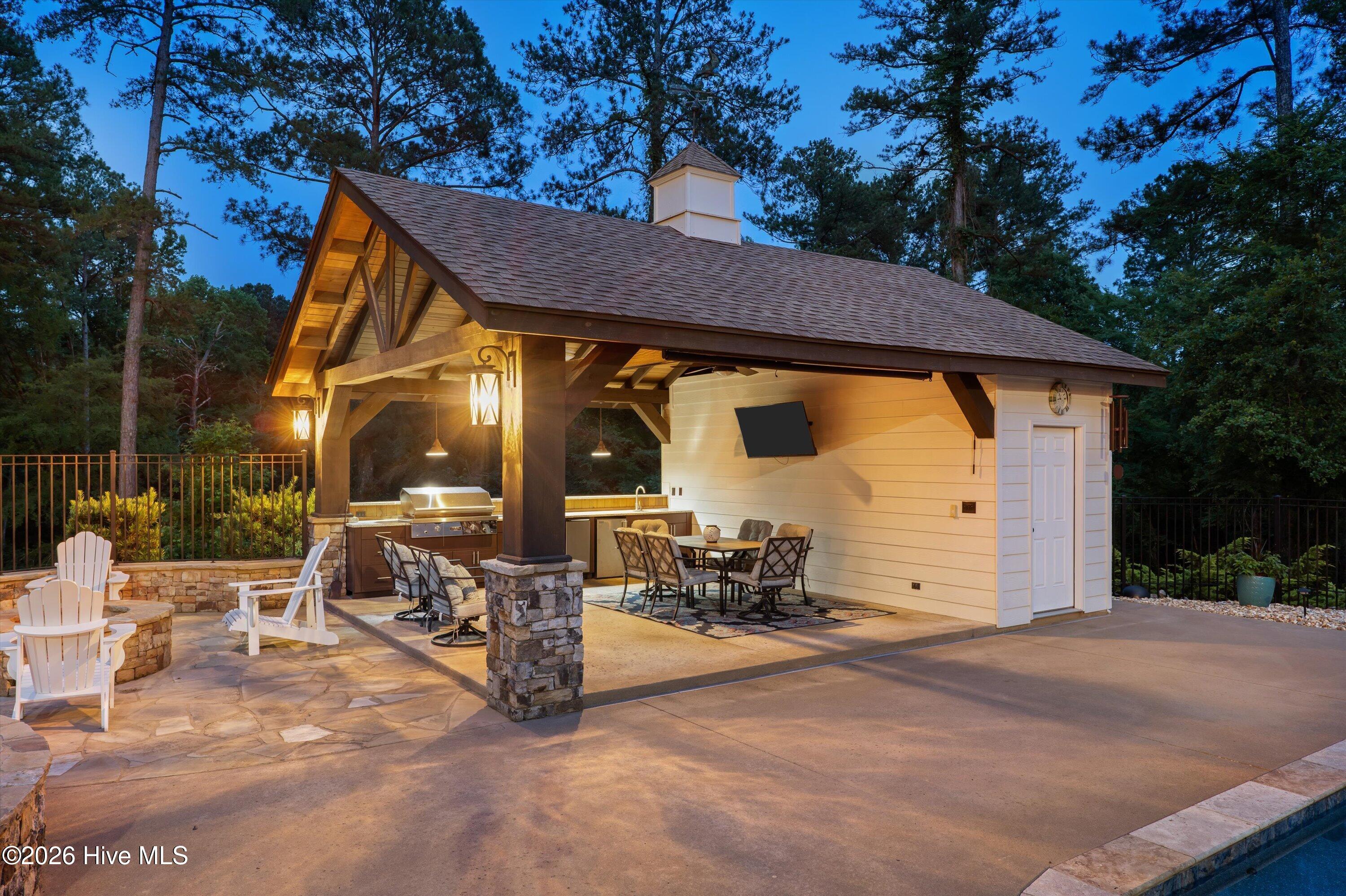 Outdoor kitchen pavilion with bathroom storage and outside shower