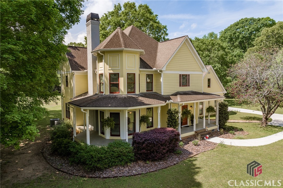 Welcome to this dreamy Victorian-style home, nestled on 3.47 private acres in Eastside’s beloved Shoal Creek Farm. From the moment you turn onto the winding driveway and catch a glimpse of the wraparound front porch, you’ll feel it—this is one of those timeless Southern homes that instantly pulls at your heart. Classic, welcoming, and full of warmth, it’s the kind of place that makes you want to slow down and stay awhile.entrance to the formal living room which is filled with natural light and features a cozy gas fireplace and rich Brazilian hardwood floors—perfect for a quiet evening or gathering with friends. Elegant leaded glass transoms frame the doorways to both the living and dining rooms, adding character and charm. The dining room easily fits a crowd—ideal for hosting holidays, dinner parties, or Sunday suppers.At the heart of the home, the kitchen will likely be your favorite gathering spot. Thoughtfully updated in 2019, it features cherry cabinetry with custom pull-outs, quartz countertops, a glass tile backsplash, and high-end appliances including double convection ovens and a whisper-quiet dishwasher. There’s also a bright breakfast area with a built-in buffet and a large walk-in pantry.Off the kitchen is a spacious, light-filled family room addition—perfect for game days, movie nights, or just unwinding at the end of the day. Custom built-ins provide stylish storage, and there’s even a tucked-away office nook with cabinets that make working from home a breeze.Upstairs, the primary suite offers a quiet retreat with Brazilian cherry floors, a cozy reading corner, dual closets, and a spa-like bath with a tiled walk-in shower, soaking tub, double vanity with granite counters, and a linen closet. You’ll also find three more generously sized bedrooms—one with its own private bath and all with brand new carpets—plus a hall bath and a handy laundry chute.Additional features include a large laundry room with sink and built-ins, a two-car garage with upstairs bonus space (perfect for a gym, studio, or teen hangout), durable hardiplank siding, and newer concrete driveway and walkways.This home is the total package—timeless style, updated features, and a setting that feels like a breath of fresh air. Whether you're sipping coffee on the porch or entertaining on the backyard patio, you’ll love the space, the privacy, and the peaceful lifestyle this home offers. Come see it for yourself—this one’s truly something special.