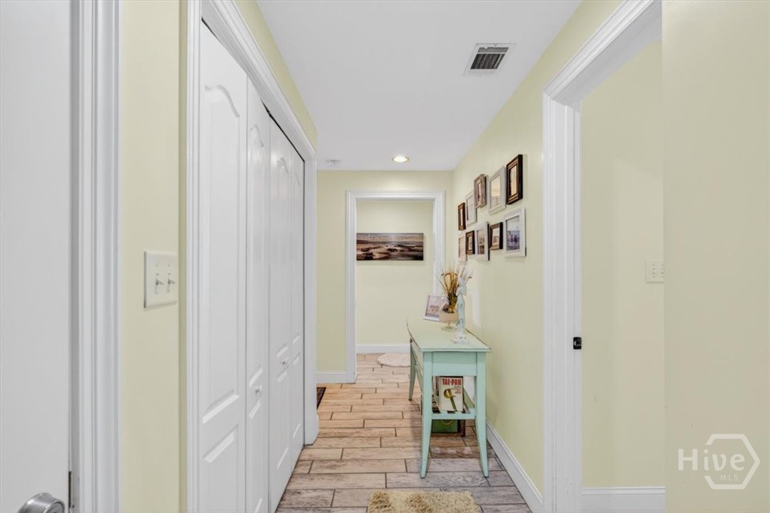 Hallway in the rear of the unit features laundry and stair access to the parking garage below.