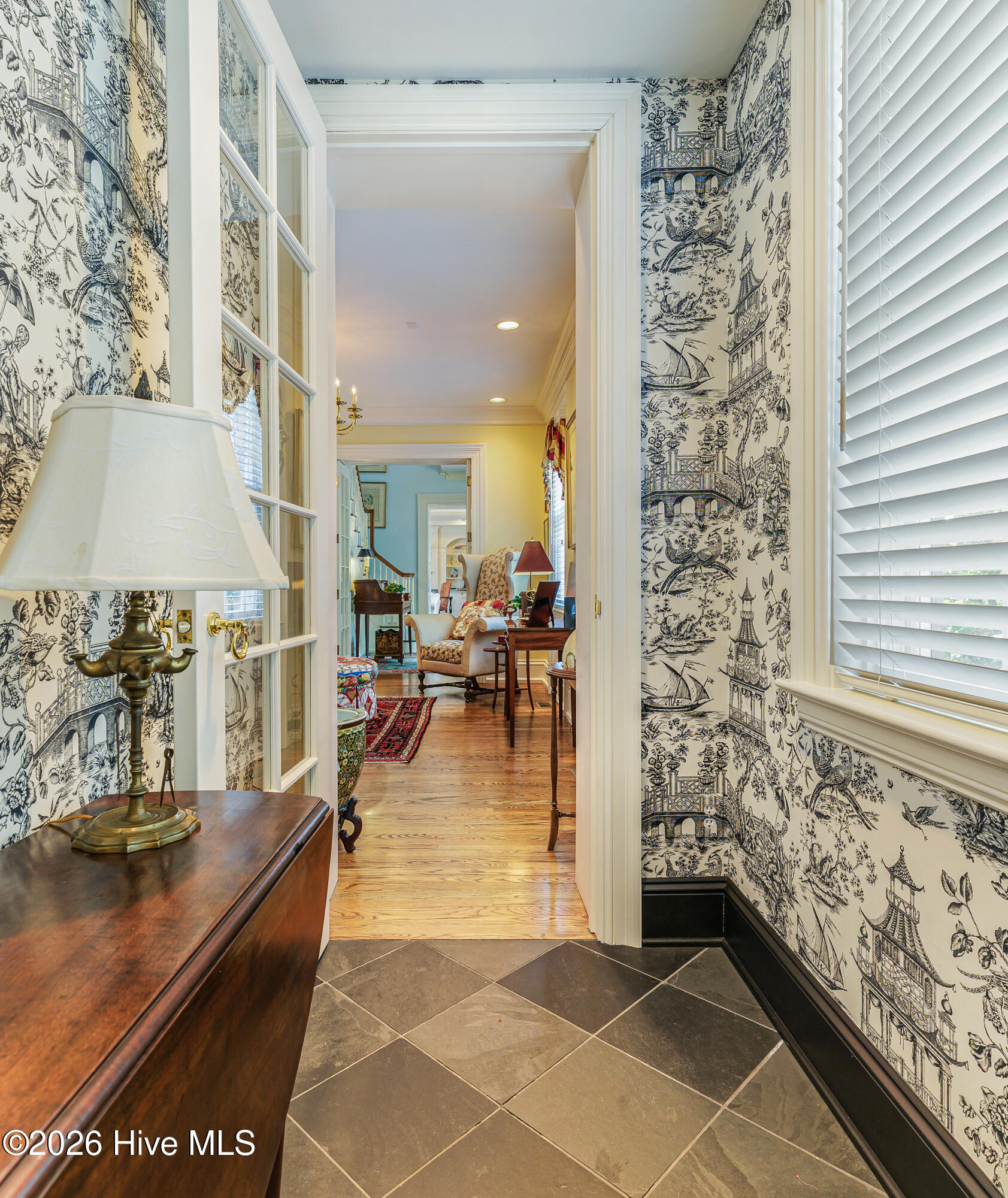 Hallway from garage leads to kitchen, garage and library