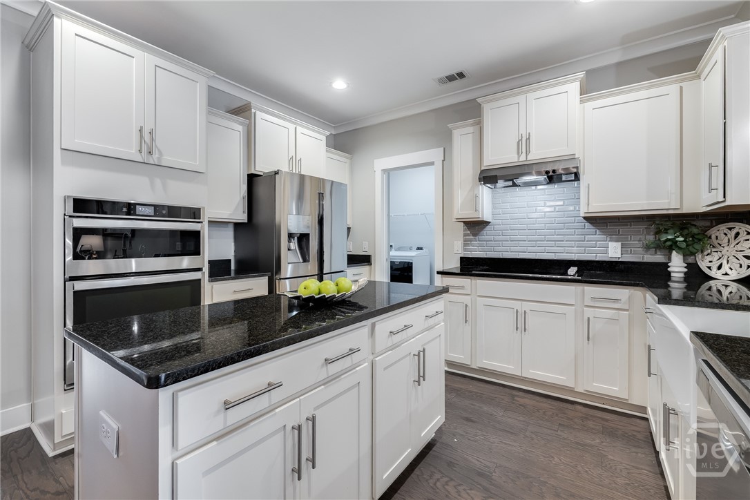 Kitchen -storage galore, view of laundry room that also houses upgraded pantry