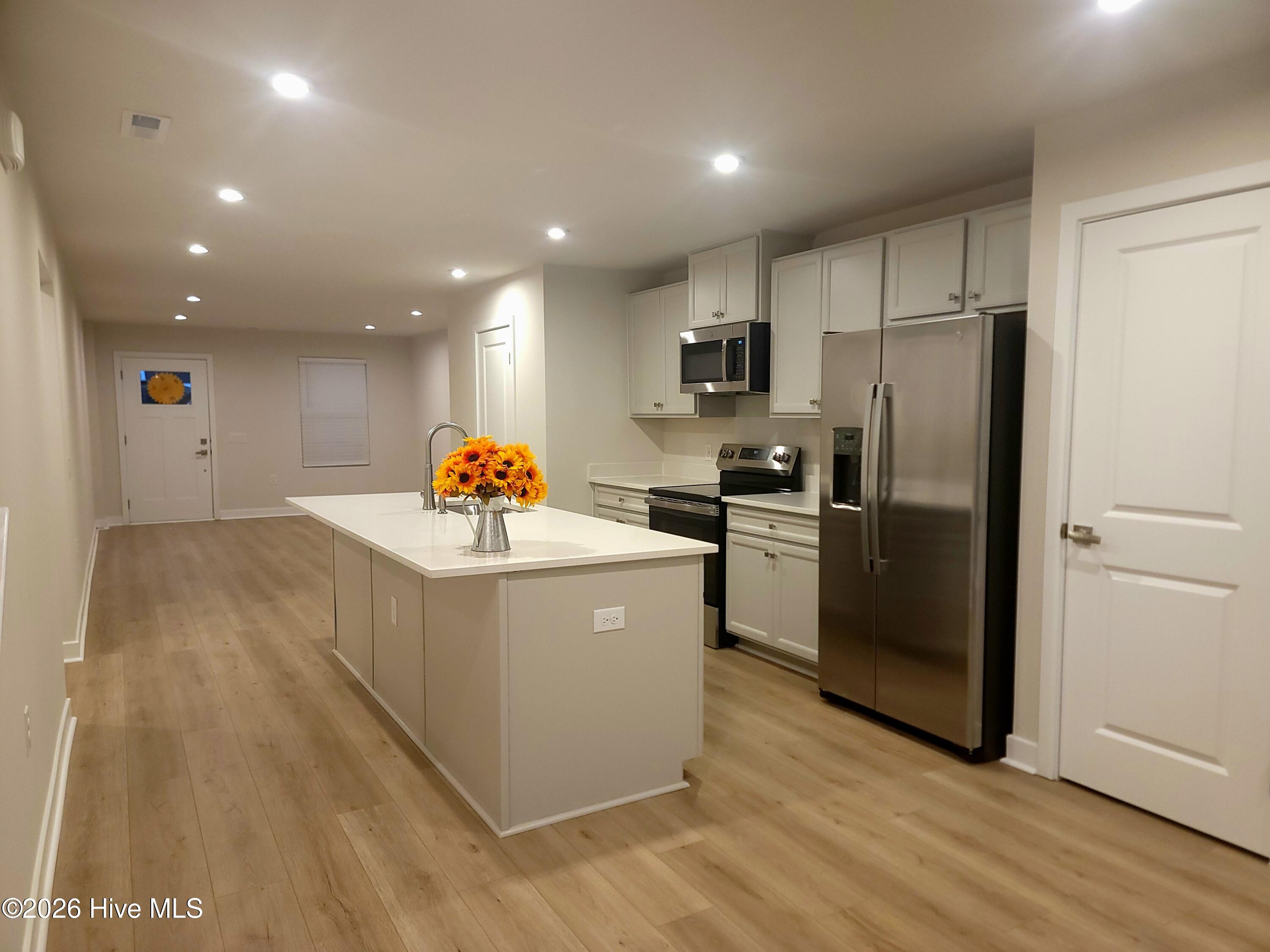 The kitchen flows right into the living room. Great for entertaining family and friends.