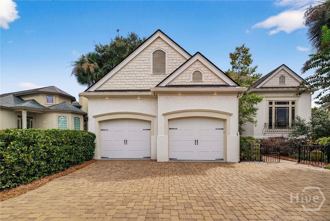Front of the home with 2 car garage and golf cart