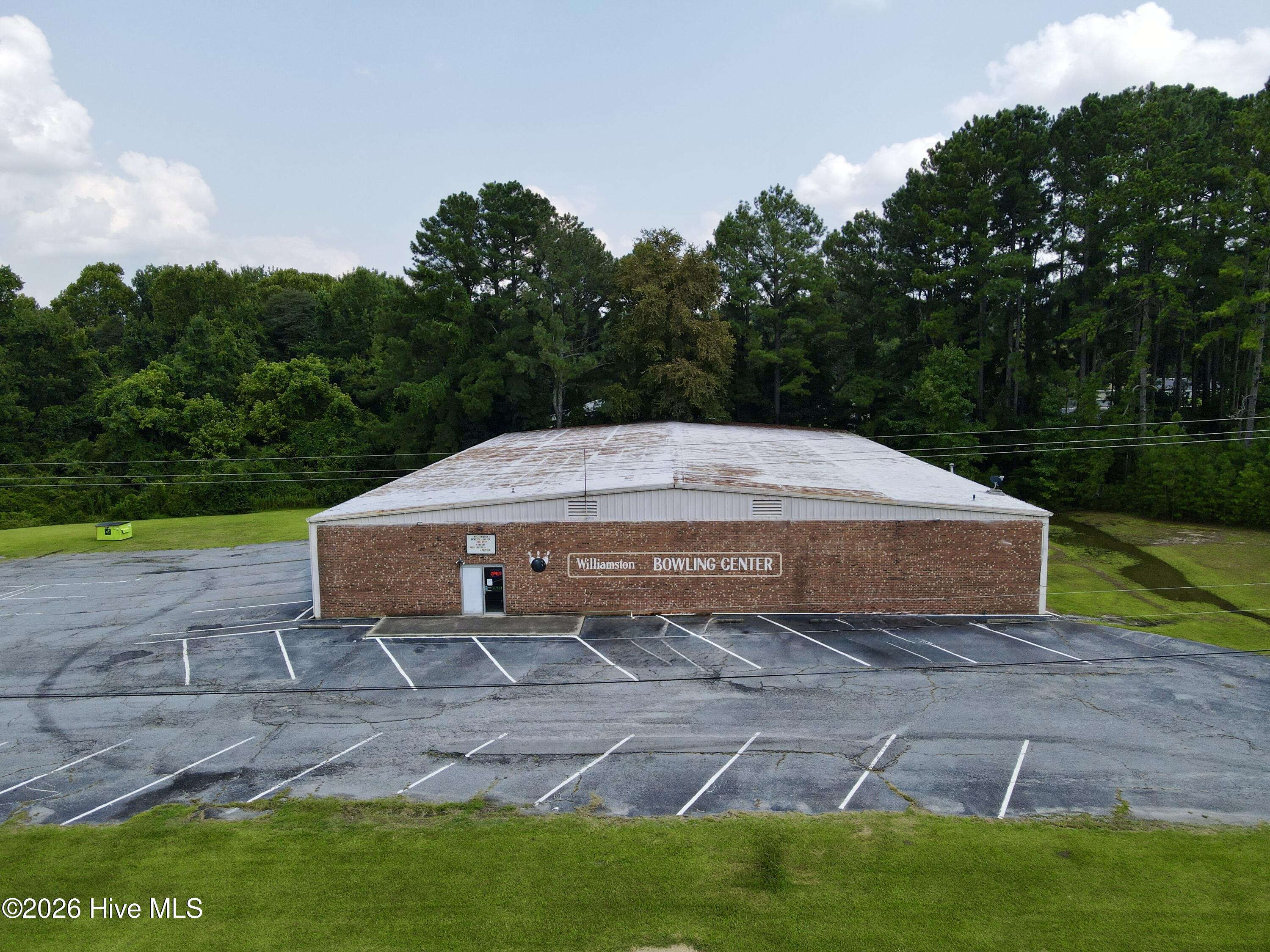 Welcome to the Williamston Bowling Center, a well-established entertainment facility prominently located along US Highway 17 in Williamston, North Carolina. In operation for more than 40 years, this 16-lane bowling center is currently operating and offers an excellent investment opportunity.The metal building features more than 14,500 square feet of heated and cooled space and includes a pool table area, gaming area, private lounge, office, reception area, and two separate restrooms. The property also includes two leased billboard sites, providing an additional potential income source.Situated on approximately 2.74 acres, the property offers a large asphalt parking lot with ample space for customers and events. Only a small portion of the property is located within a designated flood zone.This established commercial property offers visibility, accessibility, and plenty of possibilities for continued operation or future redevelopment. Take advantage of this unique investment opportunity in Williamston today!