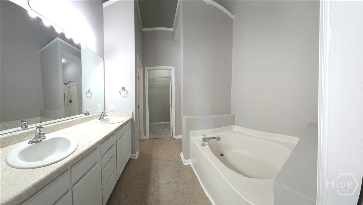 Master Bath features Double Vanities, Garden Tub and Shower.  Master Closet is at end.