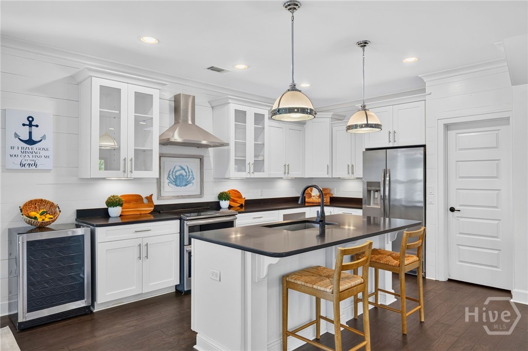 Door to the right of the fridge leads to the pantry