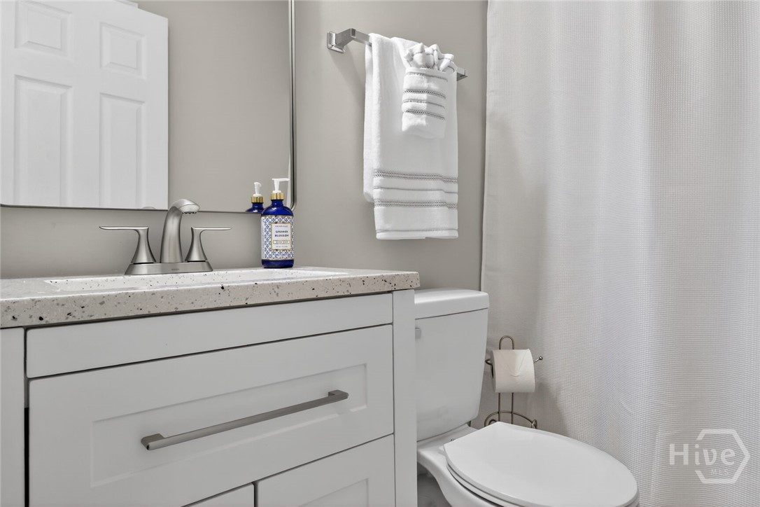 Hall bathroom has shower over tub