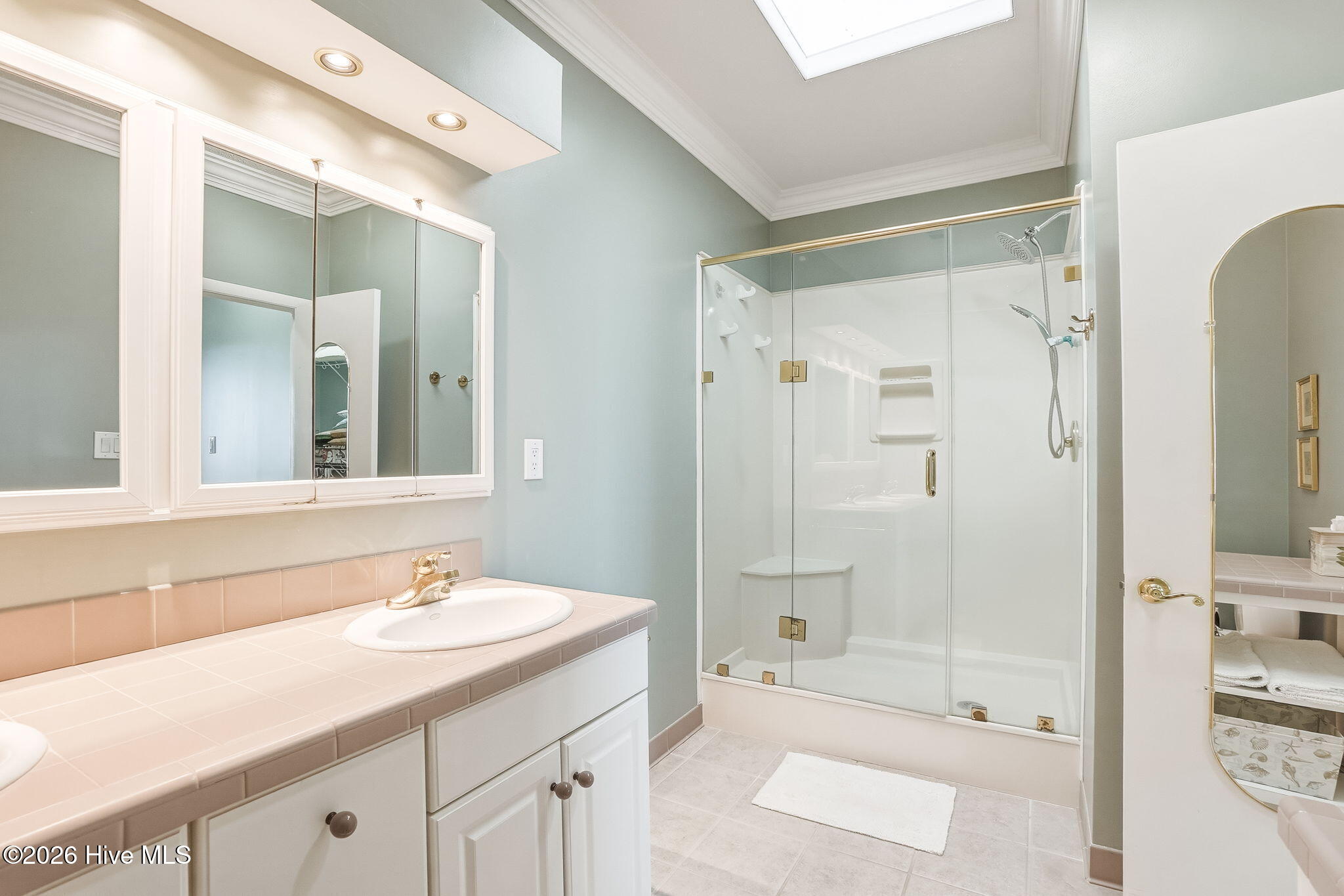 Principal Bath with glass shower and raised and double vanity