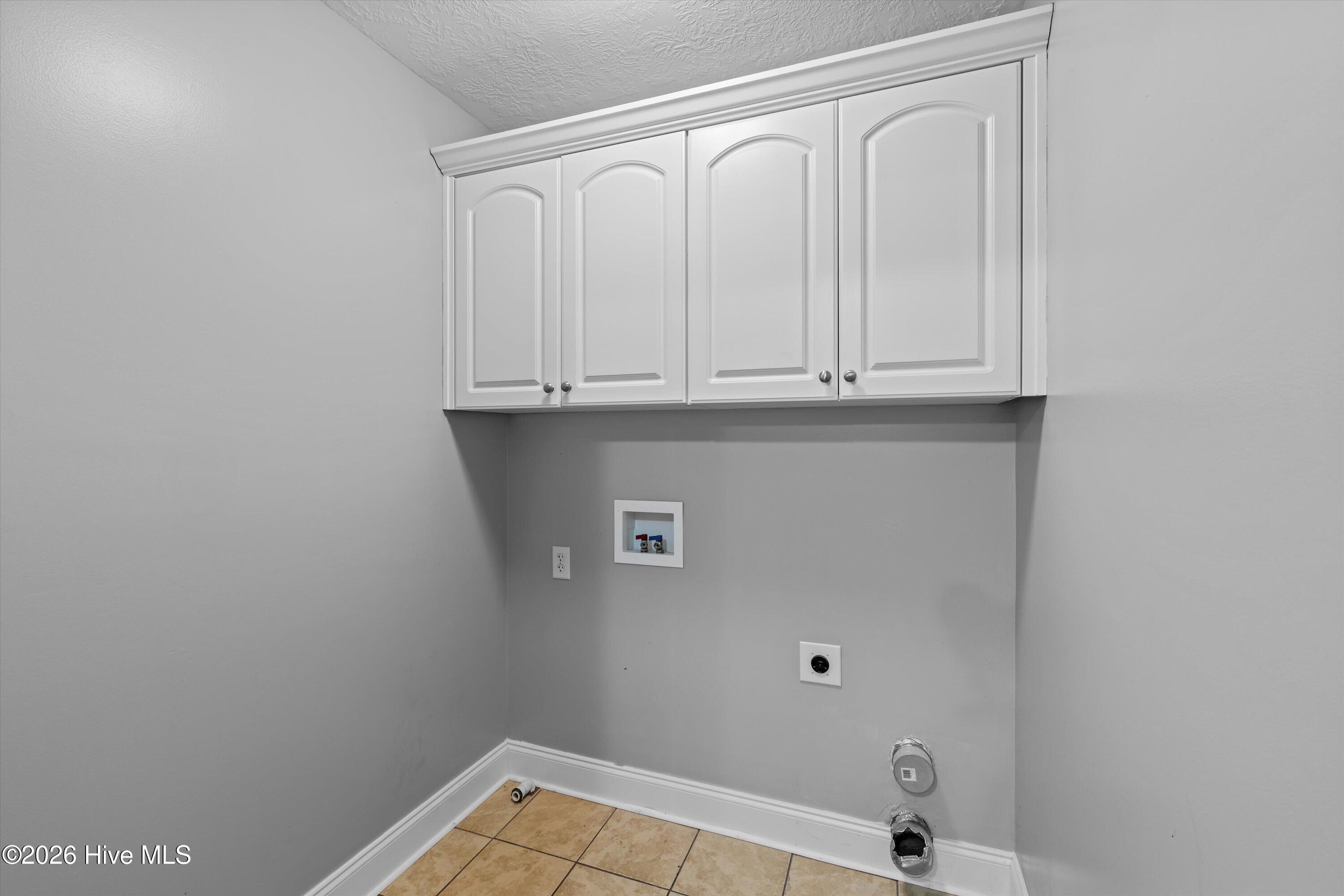 Upstairs laundry with cabinets