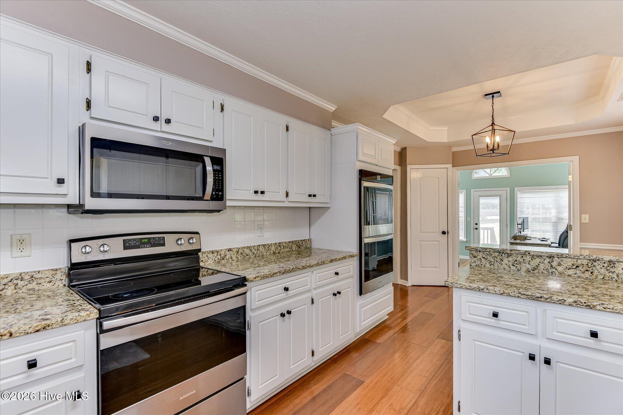 Bright cooks kitchen with 3 ovens and tons of cabinet space.