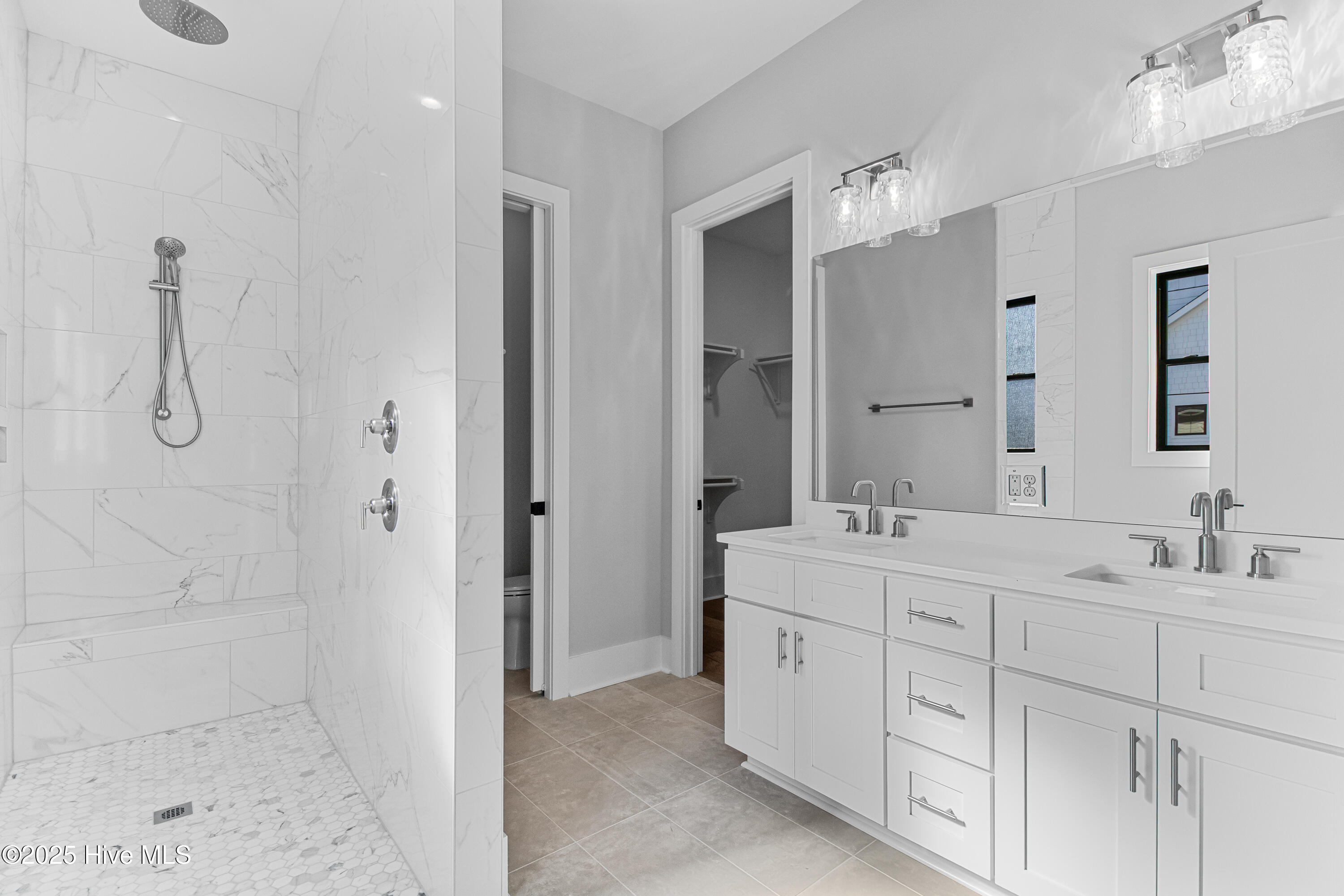 All wood cabinetry with pocket door to water closet with custom paper on walls!