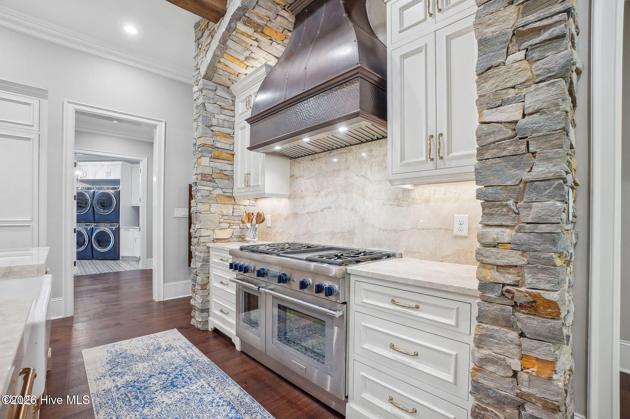 Hammered and strapped bronze and copper tone decorative hood with beautiful stone arch and heavy bea