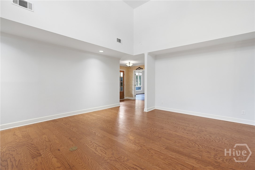 Step into the foyer and be greeted by volume ceilings, plenty of natural light, fresh paint and new hardwood flooring with a double vapor barrier.