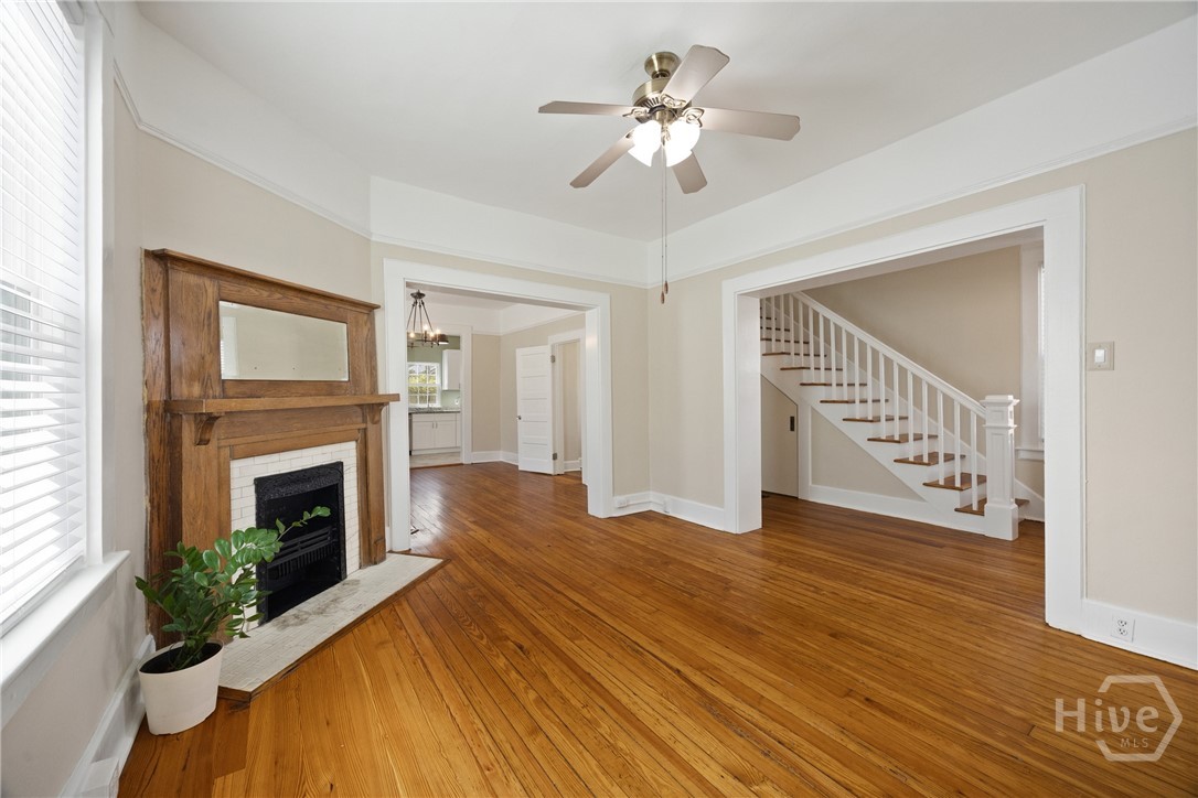 Living room with original fireplace and heart pine floors