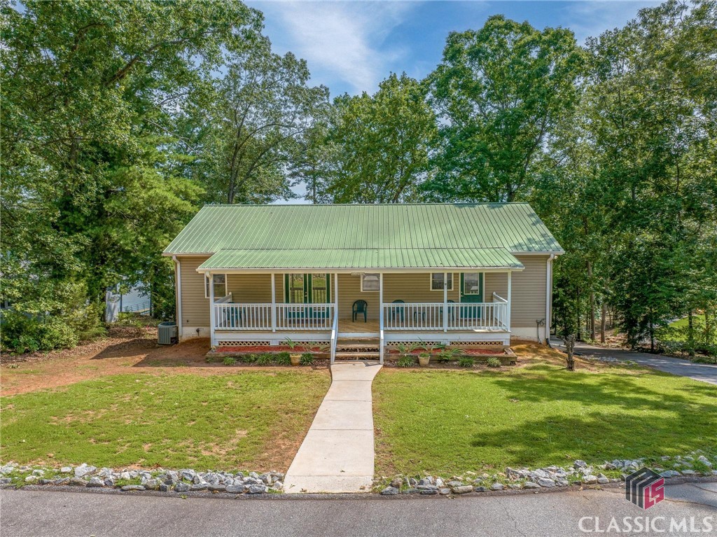 DO WHAT YOU LOVE, LIVE WHERE YOU LOVE DOING IT with this Lake Hartwell WATERFRONT ranch located in the REED CREEK area on LAKE HARTWELL. This lakeside getaway is ready for a Summer Lake Living Lifestyle. The OPEN plan welcomes ENTERTAINMENT while offering anti-stress LAKESIDE views. The perfect canvas to PERSONALIZE with your own design, this property would be perfect for multi unit short term rentals. ESCAPE to the covered deck sanctuary to decompress or RETIRE to the spacious master on main. LET YOUR IMAGINATION RUN as you design your own terrace level space which offers a kitchen area and full bath along with room for an additional bedroom and living area. STROLL down to the lakeside patio and covered dock to cast a line or RELAX by the water.