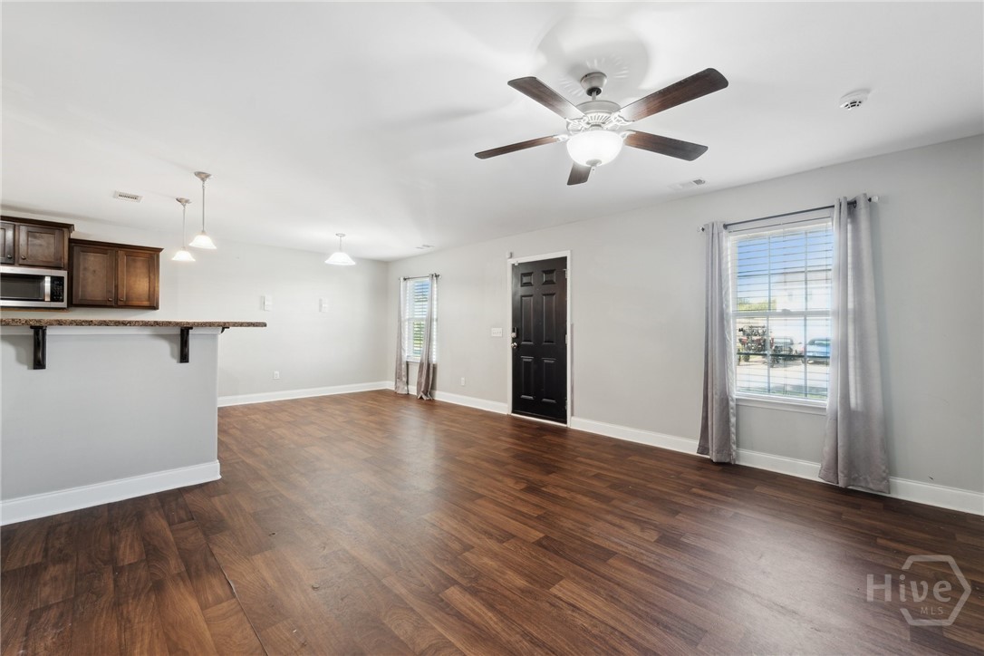 Living area looking into the dining and kitchen ar