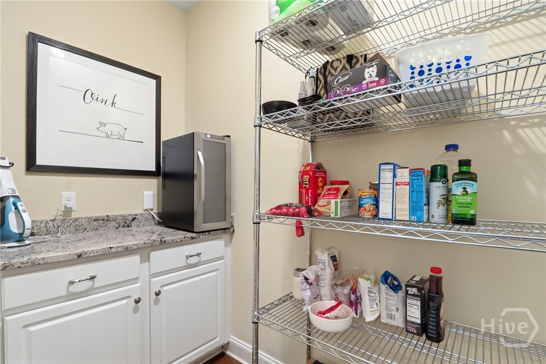 Pantry with glass doors leading to kitchen.