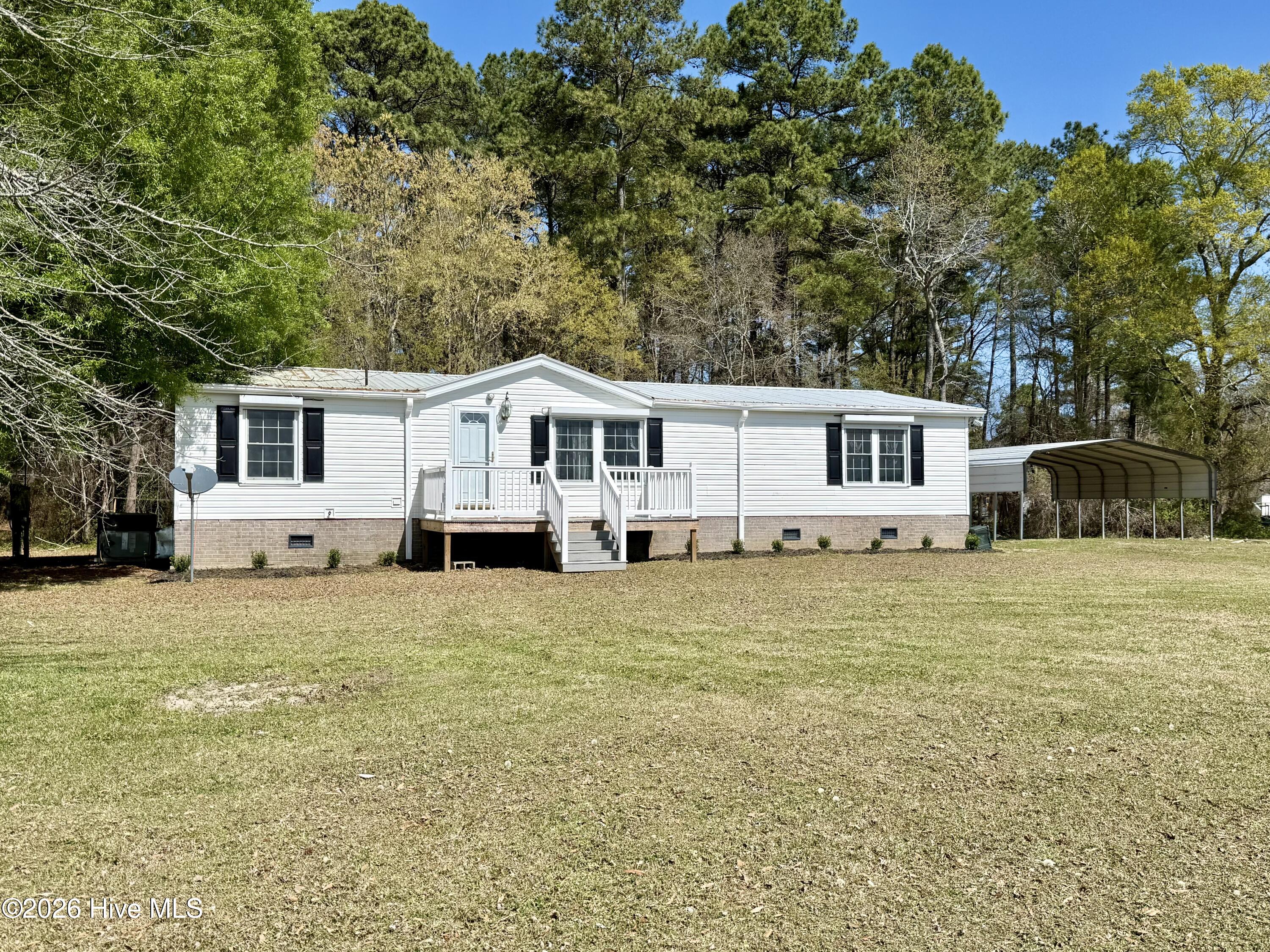Enjoy the perfect blend of comfort, space, and convenience in this inviting 4-bedroom, 2-bathroom home located just 40 minutes from Greenville. Designed for both everyday living and entertaining, this property features a spacious living room with new carpet and attractive built-in cabinets. The open floor plan flows seamlessly into the dining area and kitchen, where you will find a propane range, built-in microwave, and dishwasher.The primary suite offers new carpet, a walk-in closet, and a private en-suite bathroom complete with double vanities, a step-in shower, and a storage closet. Just across the hall is a nursery, office, or small fourth bedroom that conveniently shares access to the primary bath. On the opposite end of the home, two additional guest bedrooms each feature ceiling fans and new carpet and are served by a hallway bathroom with a tub/shower combination and single vanity.Outside, the property continues to impress with a double metal carport for covered parking, a detached metal garage/workshop, and an additional outbuilding for extra storage. A propane whole-home generator provides added peace of mind, and electric storm shutters on all windows offer extra protection and convenience. Situated on approximately 1.53 acres, this property offers plenty of room to spread out with no restrictions or zoning. The home is serviced by private well water and a private septic system, adding to its rural appeal. With space, flexibility, and valuable extras, this property is ready to welcome new owners. Schedule your private showing today.