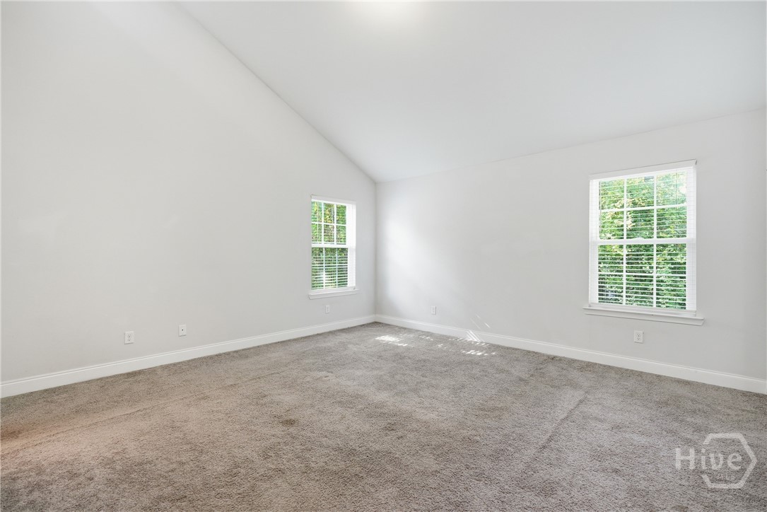 The primary suite features vaulted ceilings.