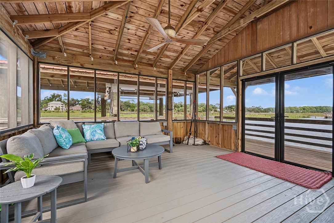 Screened-in dock house with boat lift and floating dock