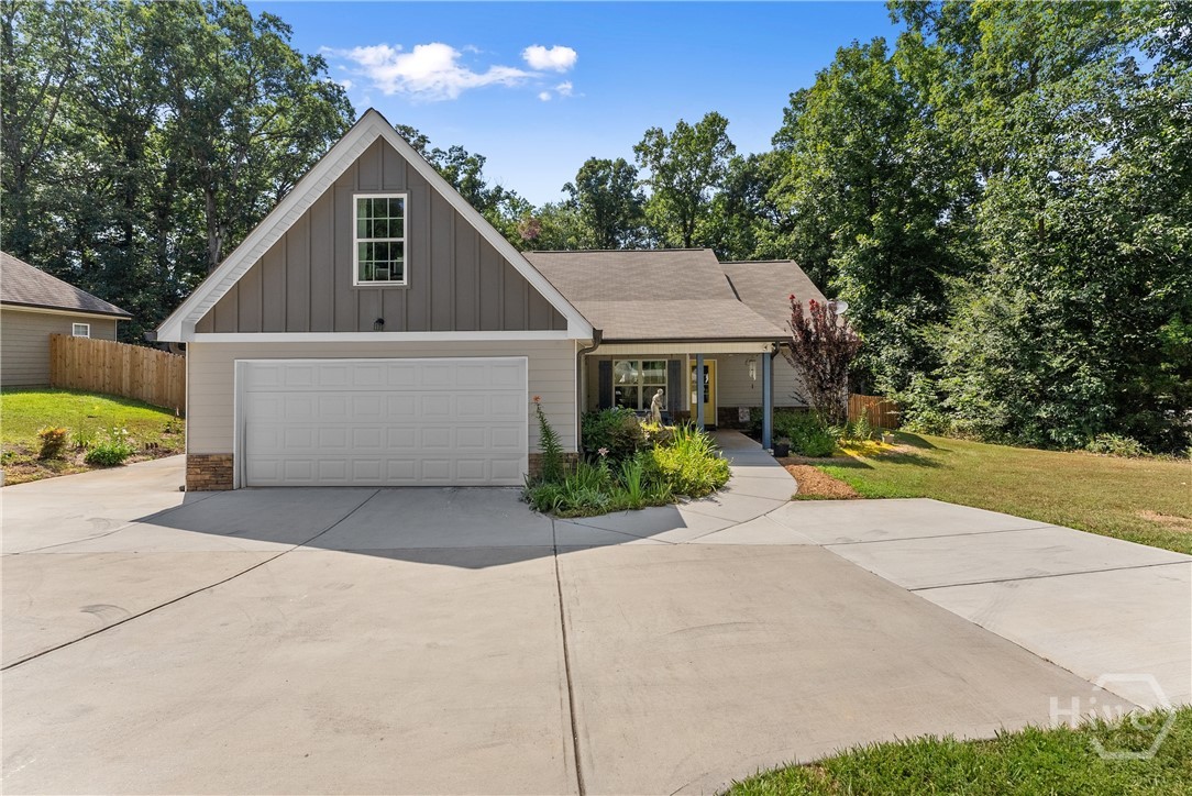 105 W E King Road Commerce, Georgia Built in 2020 and beautifully maintained, this 3-bedroom, 2-bath home blends modern convenience with natural charm in a quiet, established area. Ideally situated just minutes from Hwy 441 and a quick drive to Athens, it's a peaceful retreat with easy access to everything you need. Inside, you'll find a thoughtfully designed split-bedroom floor plan offering both space and privacy. The cozy living room features a fireplace that invites you to kick back and relax, while the spacious bonus room over the garage offers flexibility for a home office, playroom, workout space, guest retreat, or creative studio. The kitchen and breakfast area are light-filled and functional, with tall shaker cabinetry and warm granite countertops. Practical features include a two-car garage, extra parking pad for guests or additional vehicles, a covered from porch with a swing for relaxing and a rear patio overlooking the fenced back yard. The yard is generously sized with multiple areas perfect for a fire pit, hammock, or simply taking in the peaceful surroundings. The homeowner carved out a peaceful, natural area that's perfect for watching the birds or other native wildlife. With its excellent condition, charming layout, and outdoor personality, this home is ready for its next chapter. Come see it for yourself - your next home might just be waiting!