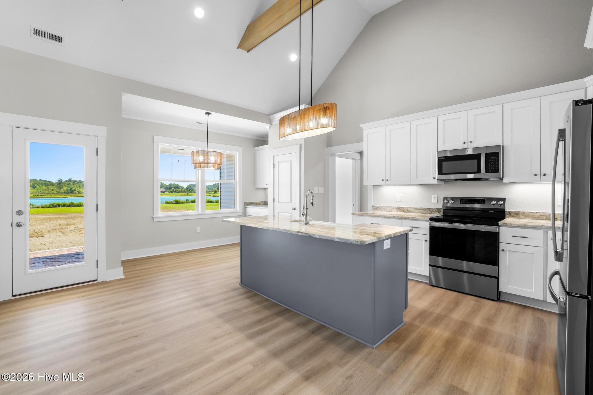 Beautiful center island w/ white cast iron farm sink.