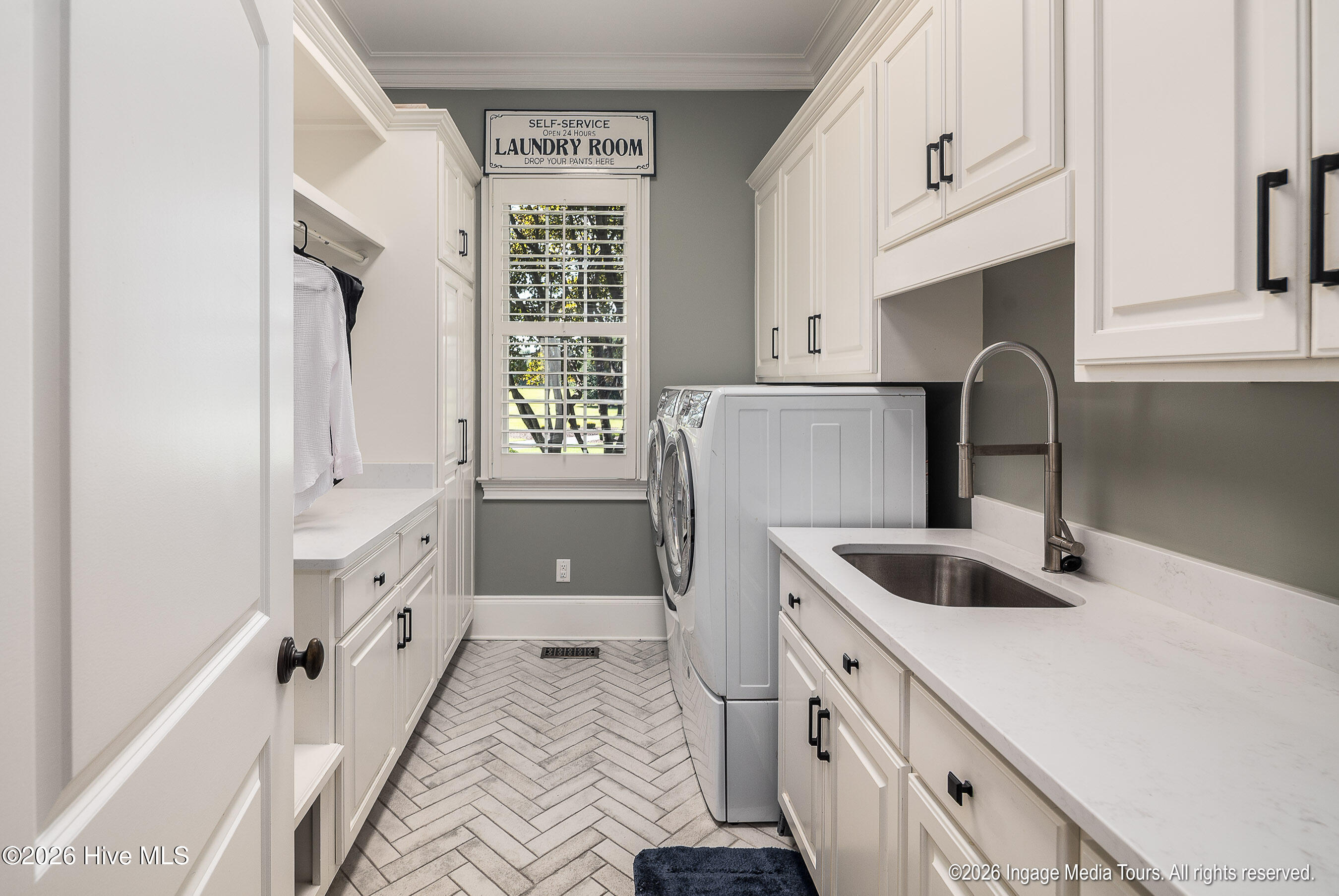 Laundry Room with sink, hanging space and open locker space