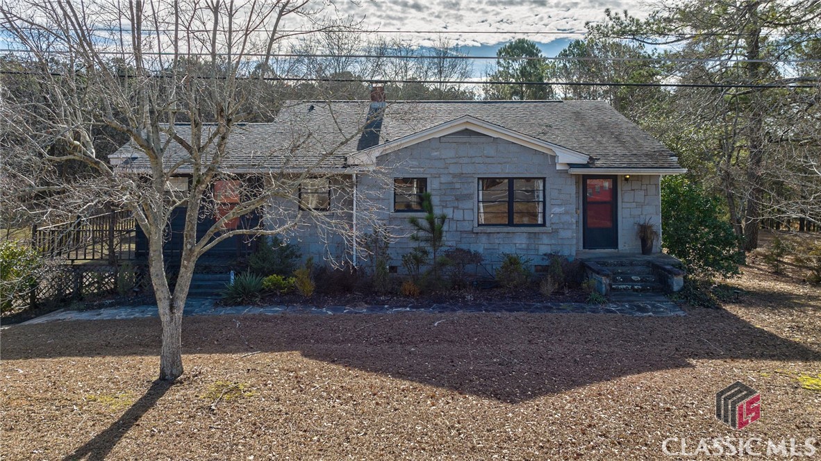 Just Listed in Elberton! Don't miss this charming, stone constructed ranch home over partially finished basement all sited on 4.73 acres. Several barns and storage sheds have been constructed over the years throughout the property, one of which is wired and serves as a guest suite. Inside the main home you'll find original hardwood flooring throughout the main level. Walls have been removed to create a more open floor plan that is very spacious. Three bedrooms share an updated hall bathroom with new tile. The basement level features one bedroom, a full bathroom, and an unfinished dean area with laundry. Enjoy the views of this private property from the wooden deck. Attached carport provides parking at the rear of the home. Endless possibilities for potential use of this property and its many structures!