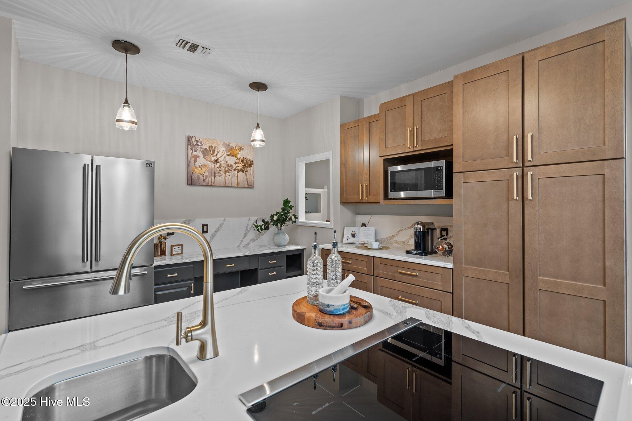 Island with sitting bar, secondary sink and wine rack