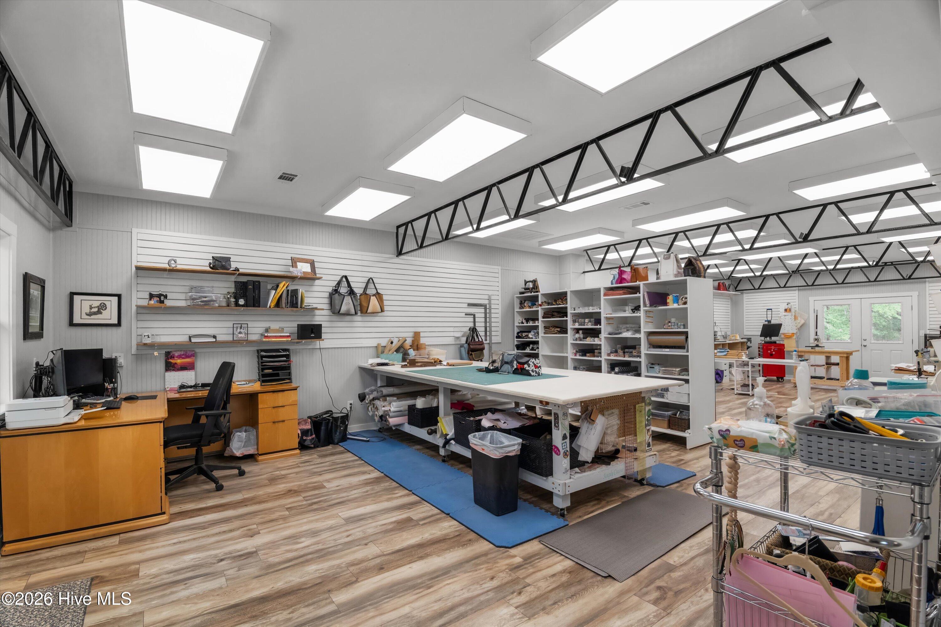 Other half of workshop has been custom updated for home business to include waterproof LVP flooring, half bath and kitchennette