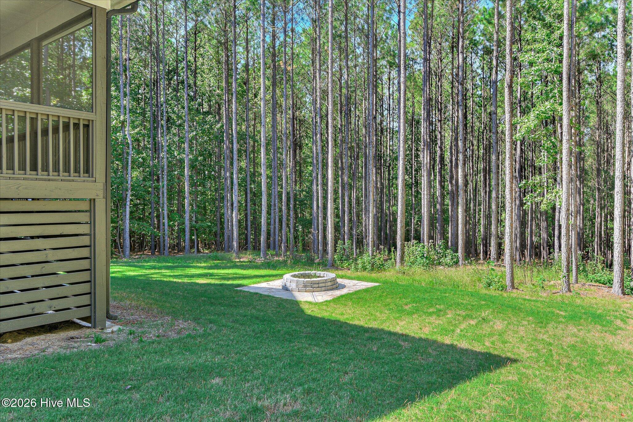 Large backyard with fire pit and trail to the lake, lot is dockable when water levels return to normal.