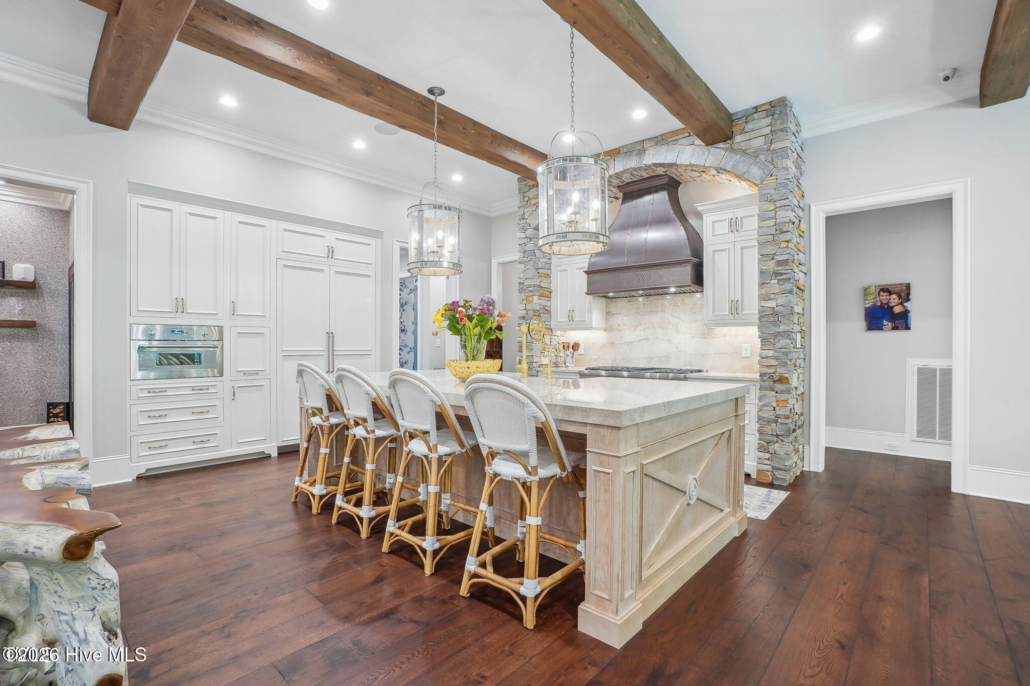 Huge single slab laminated island with hidden Miele dishwasher dovetail drawers