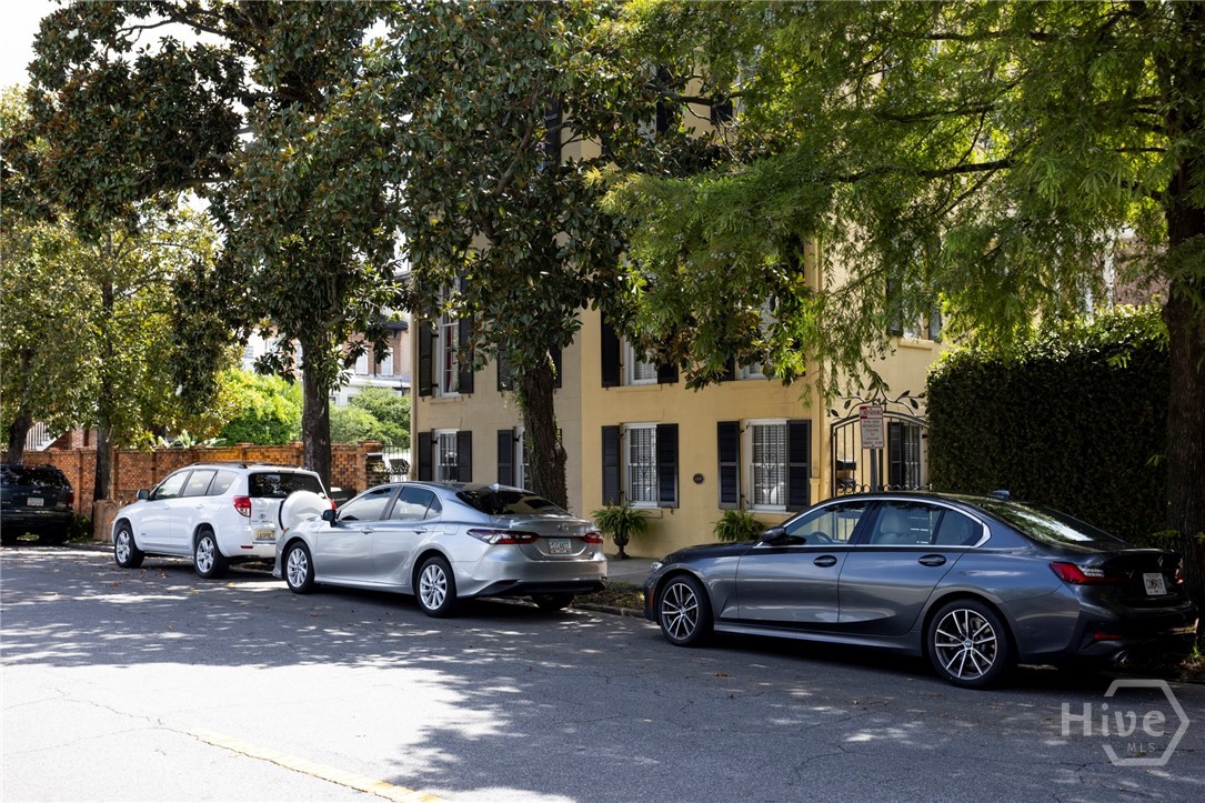 View of property & tree-lined street from across t