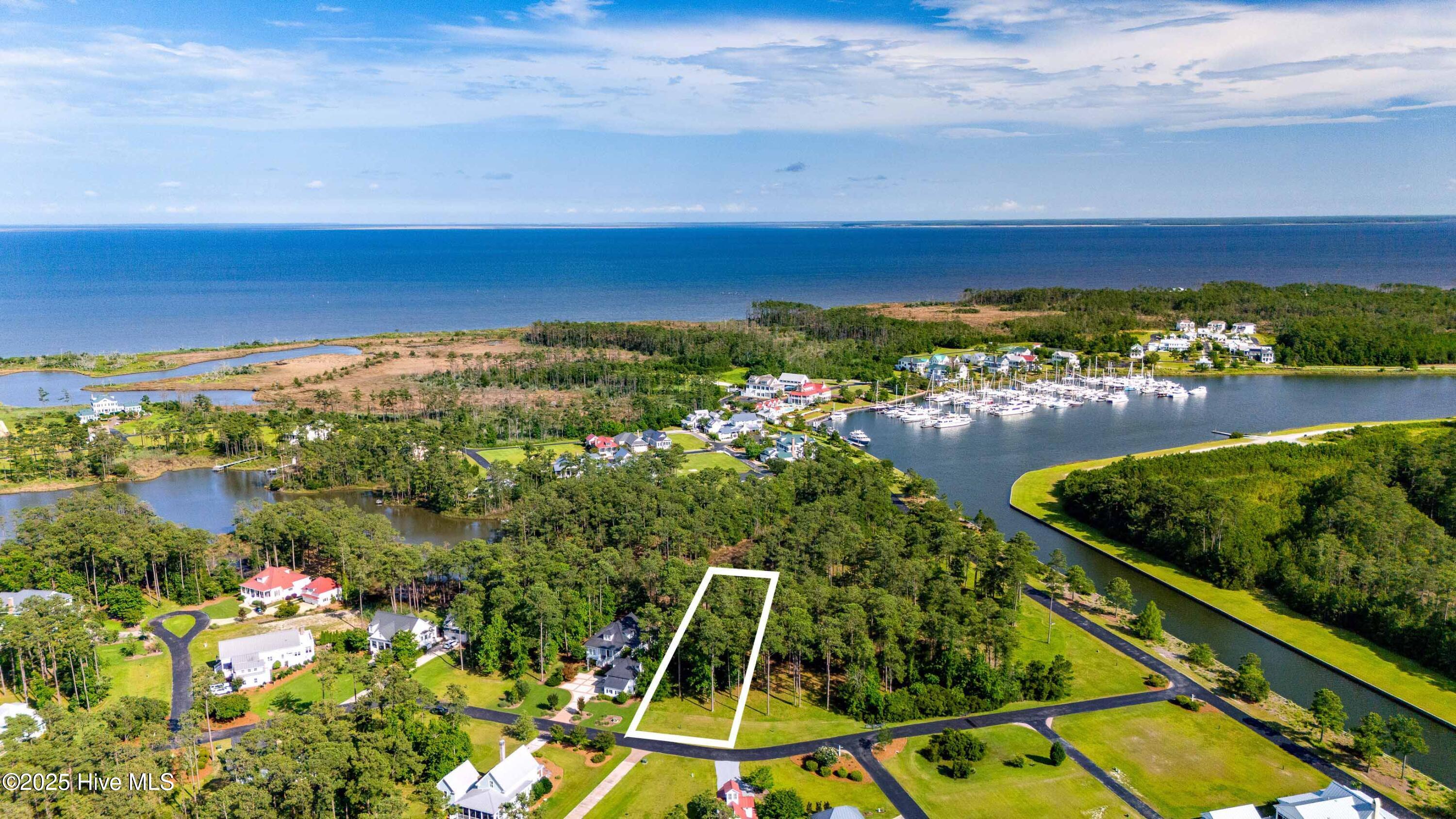 88 Oyster Point Road Oriental, North Carolina Nestled within the prestigious River Dunes community, this exceptional 0.61-acre homesite offers a unique opportunity to build your dream coastal retreat. Situated on a creekfront lot, the property offers serene water views and is just a short walk from Harbor Village—the heart of River Dunes.
River Dunes is renowned for its award-winning architecture and commitment to the boating lifestyle. Residents enjoy access to Grace Harbor Marina, a 400-slip inland basin marina that provides deep-water access to the Intracoastal Waterway, Pamlico Sound, and the Neuse River. The community also features a private Harbor Club offering both formal and casual dining, a luxury spa, a provisions store, and a local café. Outdoor enthusiasts will appreciate the biking and kayaking opportunities, as well as the overall coastal living experience that River Dunes provides.
This homesite is perfect for those seeking a retirement haven, a second home, or an investment property.