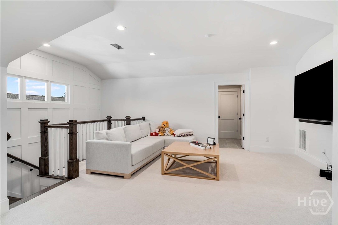 LOFT AREA WITH DOOR TO UPSTAIRS LAUNDRY