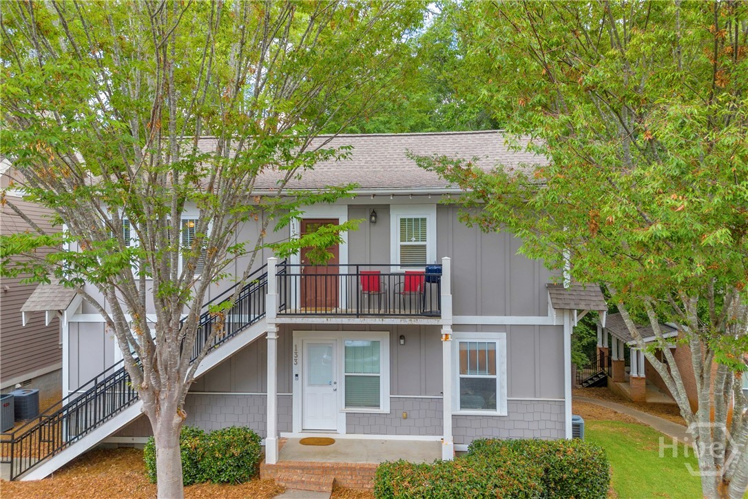 Located in the highly sought-after Woodlands of Athens, this spacious 2-bedroom, 2-bathroom condo offers the perfect blend of comfort, convenience, and investment potential. Just minutes from UGA, downtown Athens, and Loop 10, it’s a prime spot for students, professionals, or anyone looking to be close to it all.  This cottage-style building features one of the most desirable layouts in the community, and this unit occupies the entire upstairs, offering added privacy. Step inside to find an inviting open-concept floor plan with a bright kitchen featuring white cabinetry and bar seating, overlooking the large living area with built-in shelving.  Both bedrooms are generously sized, each with walk-in closets and private access to full bathrooms—perfect for roommates or guests. You'll also love the laminate hardwood flooring throughout—no carpet!  Residents of The Woodlands enjoy access to resort-style amenities, including a clubhouse, swimming pool, tennis courts, basketball and volleyball courts, and more.  Don’t miss this fantastic opportunity to own in one of Athens' most desirable gated communities!