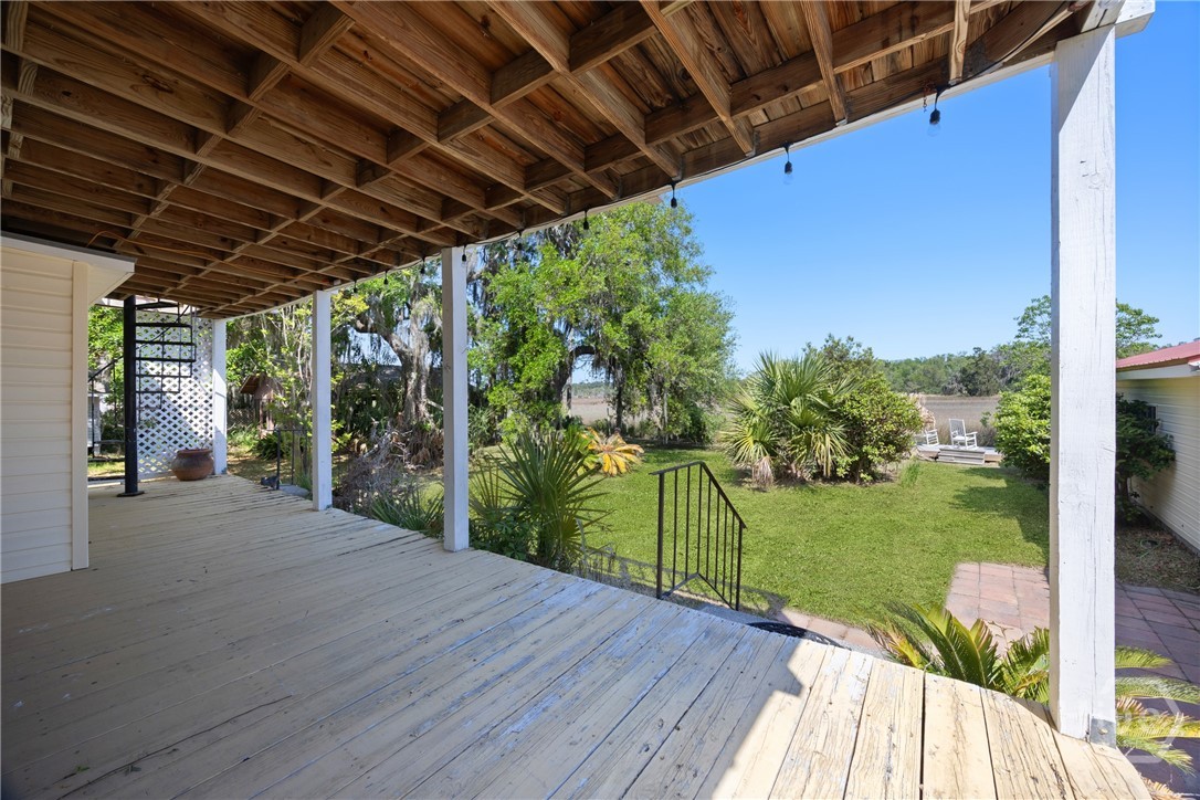 Covered back porch overlooking the backyard, a per
