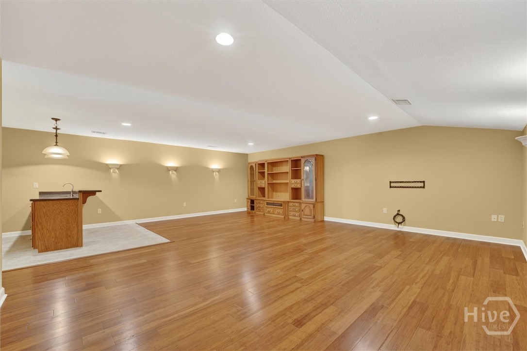 Upstairs media/bonus room with wet bar.