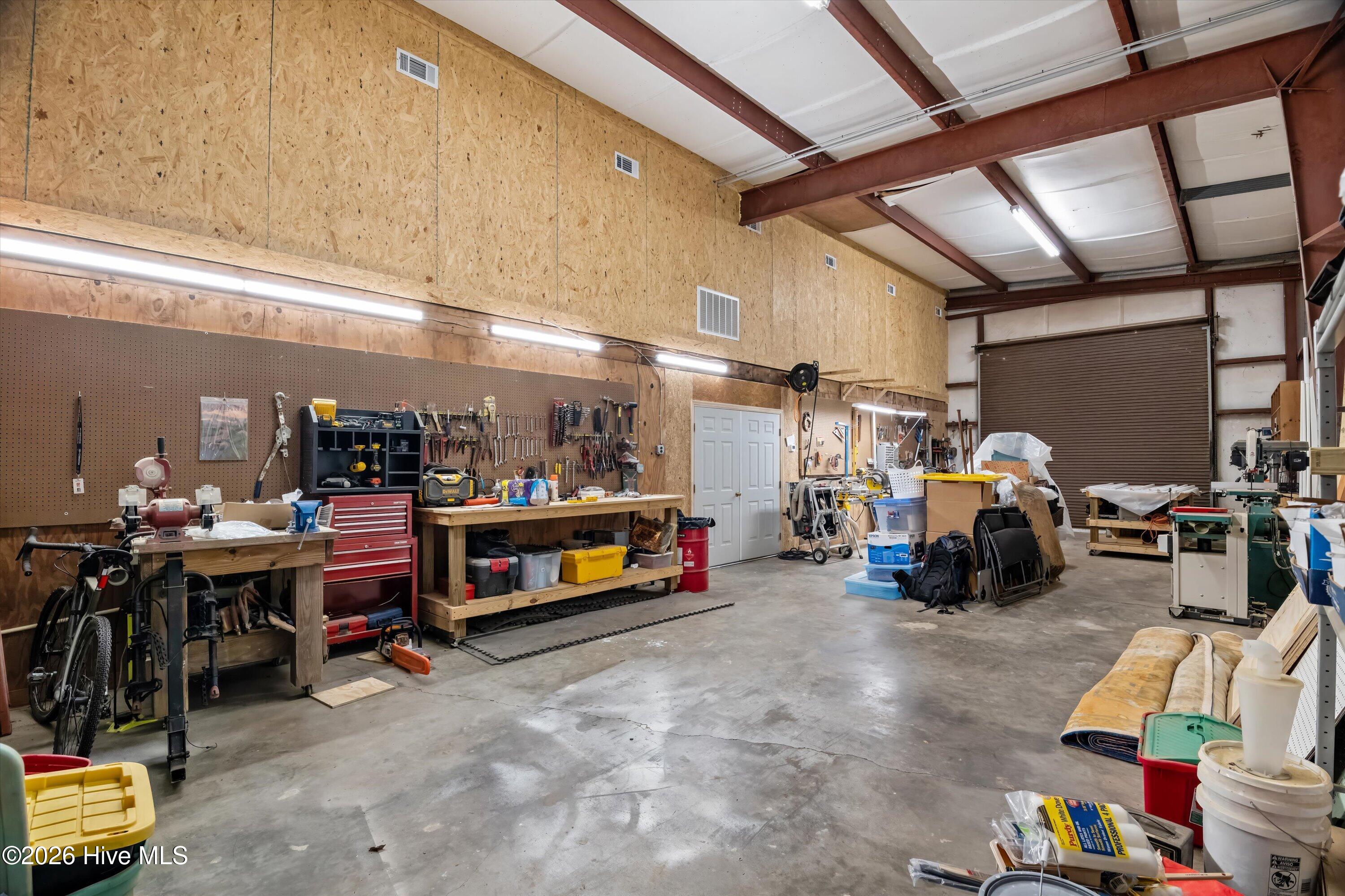 One side of workshop with roll up doors perfect for storing boats, RV or car collection