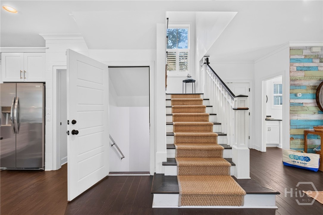 door to left of the stairs leads to garage
